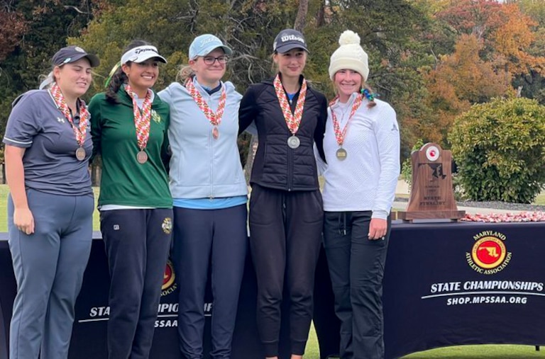 Zoe Cusack, right, after winning back-to-back individual state championship titles.