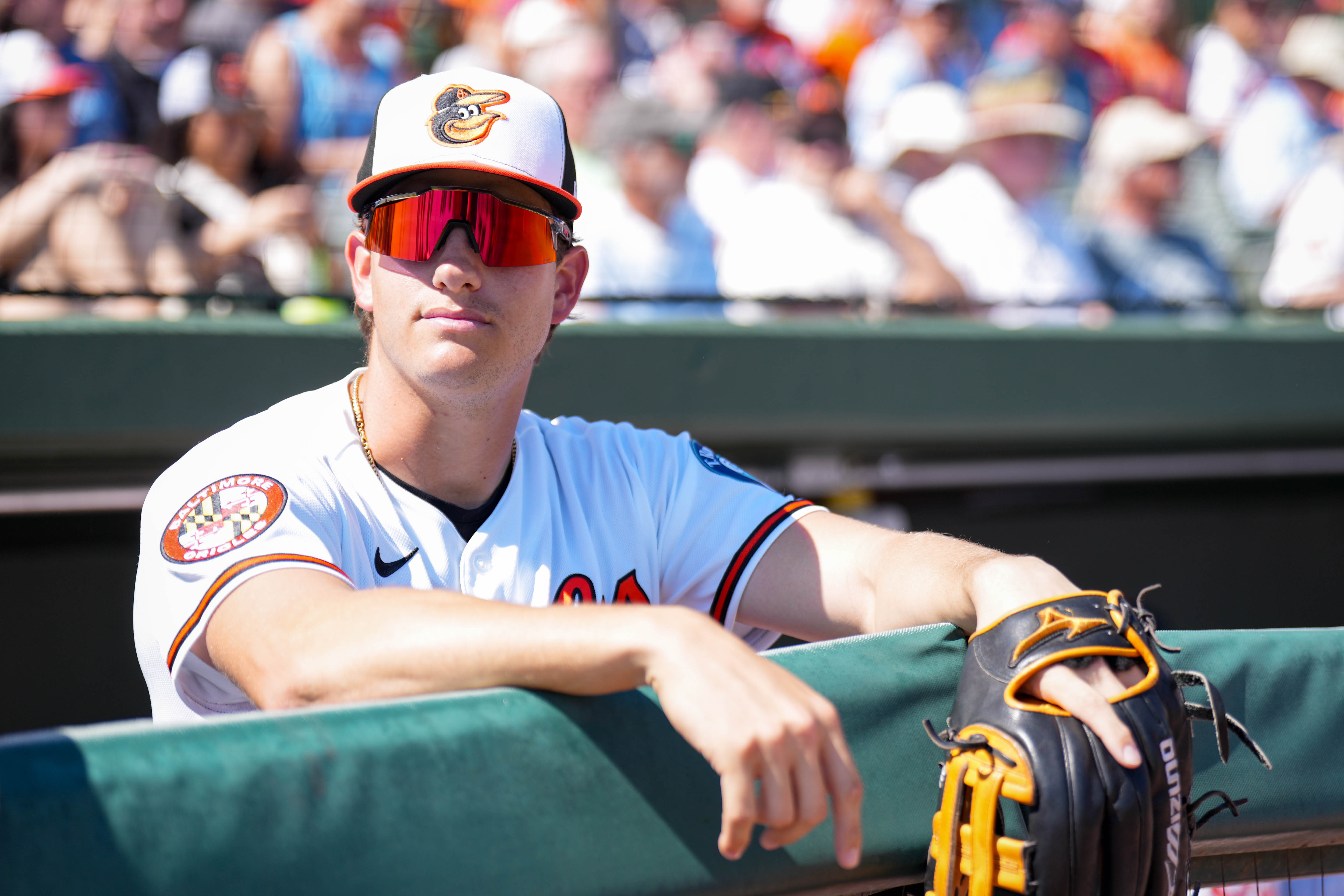Orioles third baseman Coby Mayo looks out at the field from the dugout ahead of a spring training game against the New York Yankees on Feb. 20.
