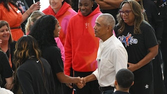 Former President Barack Obama greets WNBA All-Star Angel Reese, left, during a practice at the Obama Presidential Center in Chicago, Friday, July 24, 2026. (AP Photo/Paul Beaty)