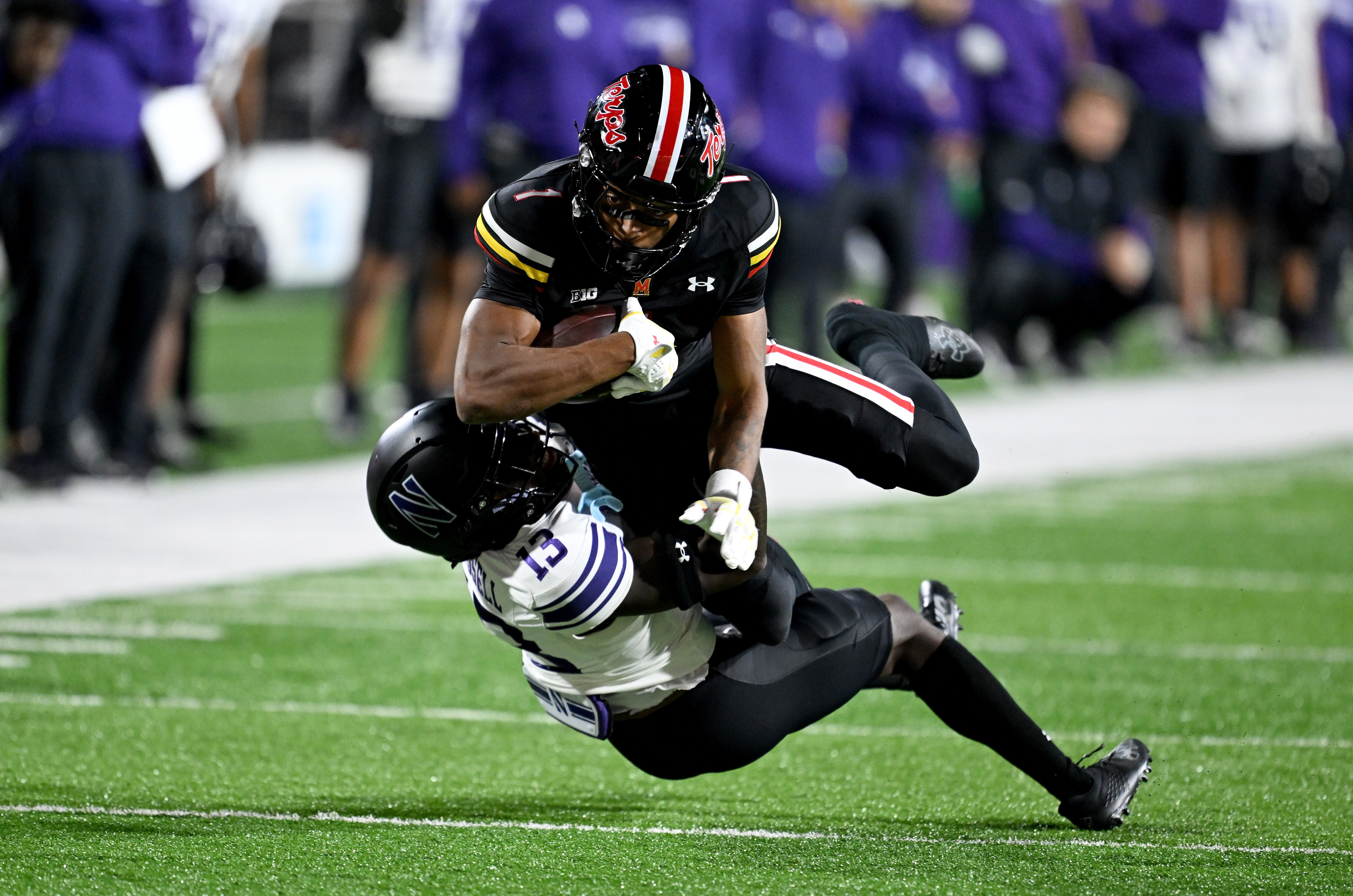 Kaden Prather of Maryland is tackled by Josh Fussell of Northwestern during the fourth quarter Friday night in College Park.