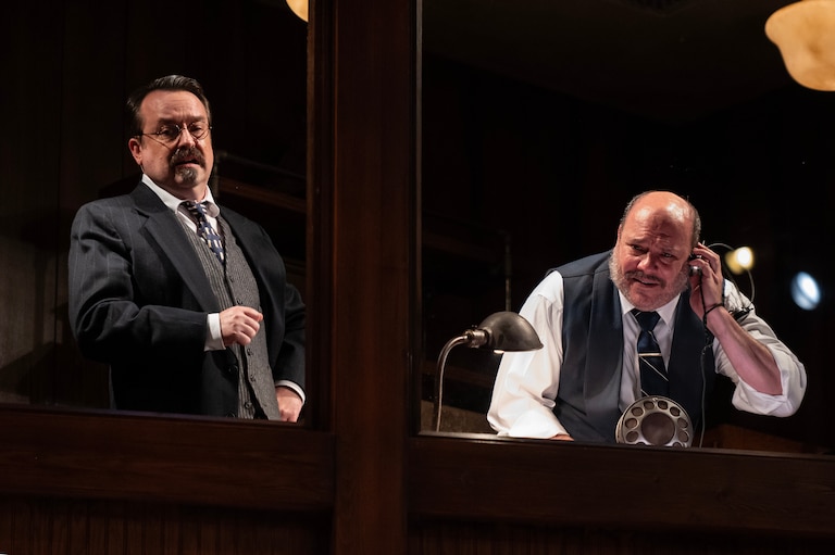 Producers Irvin, played by Michael Glenn, and Sturdyvant, played by Chris Genebach, look down on Ma Rainey’s recording session from the highest of the set’s three tiers.