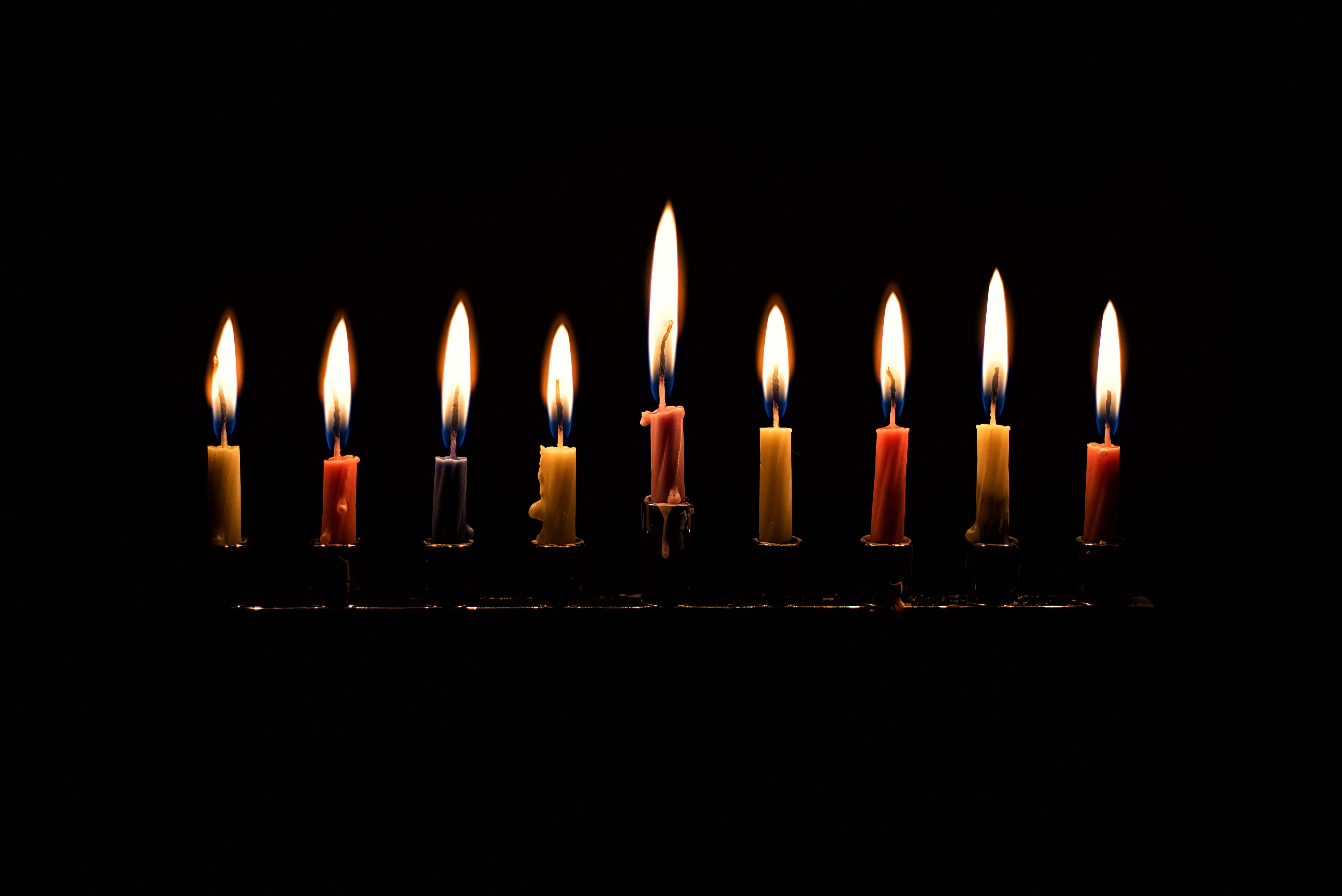 Hanukkah candles burning on the last night of Hanukkah.