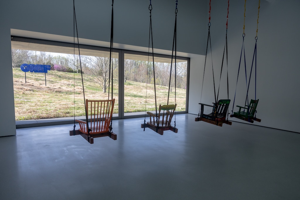 THURSDAY, APRIL 9, 2026 - A work by Andrea Bowers within the Glenstone Museum invites visitors to sit and observe the landscape, where an installation of the word "Grief" is displayed outside.