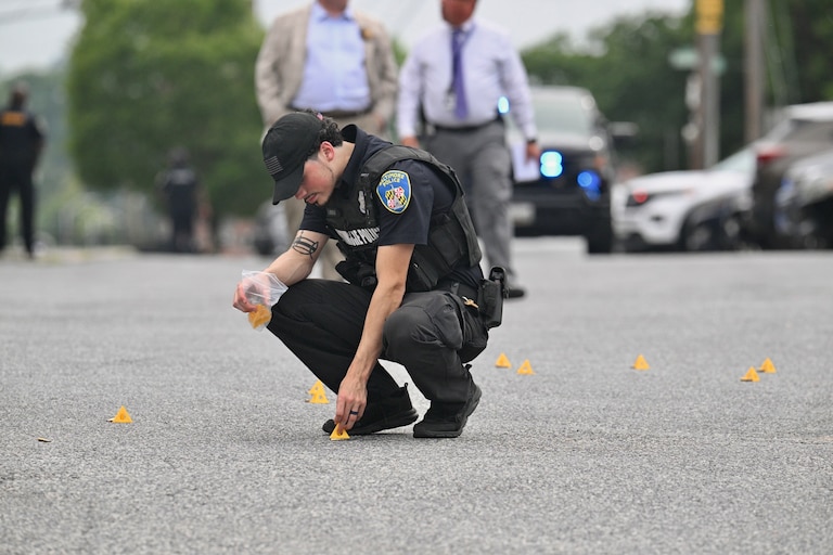 Baltimore Police mark shell casings on the pavement after a multiple shooting outside a strip shopping center on Cold Spring Lane in Northeast Baltimore on Friday, July 10, 2026.