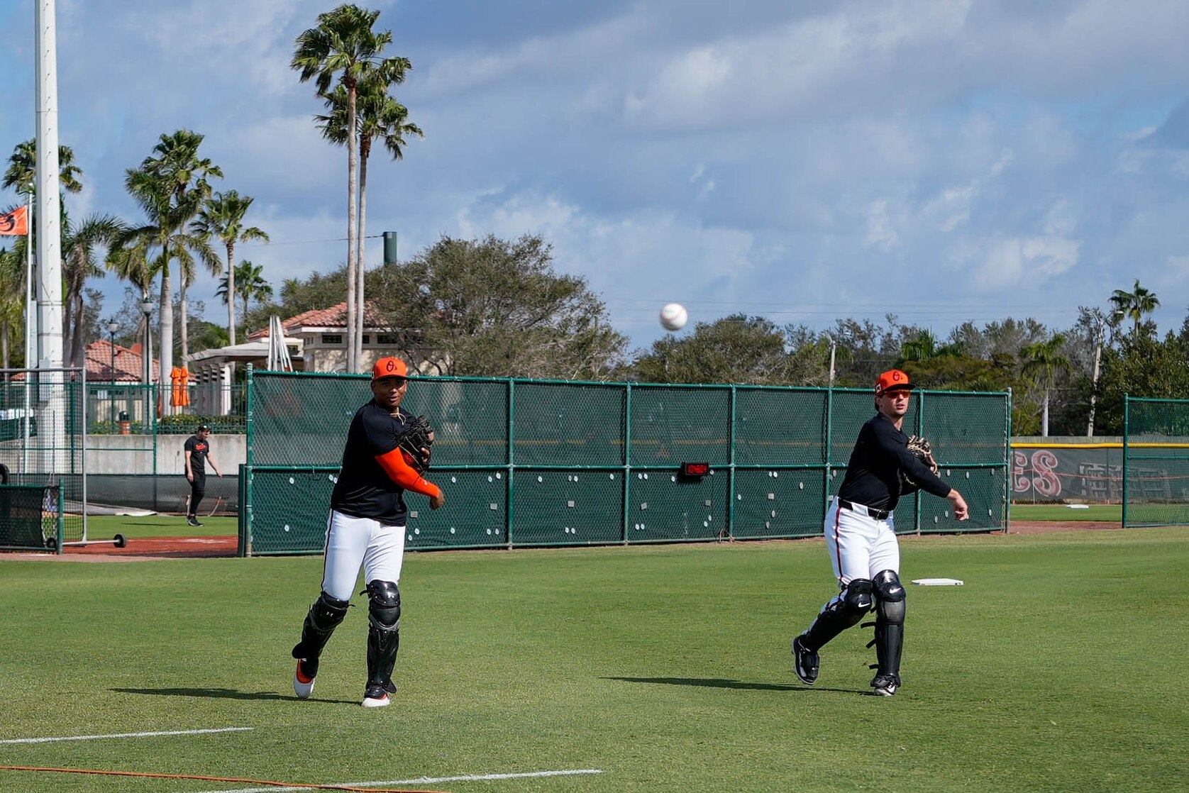 Baltimore Orioles catching prospect Samuel Basallo, left, and catcher Adley Rutschman throw to coaches during Spring Training at Ed Smith Stadium in Sarasota, Fla. on Tuesday, February 18, 2025.