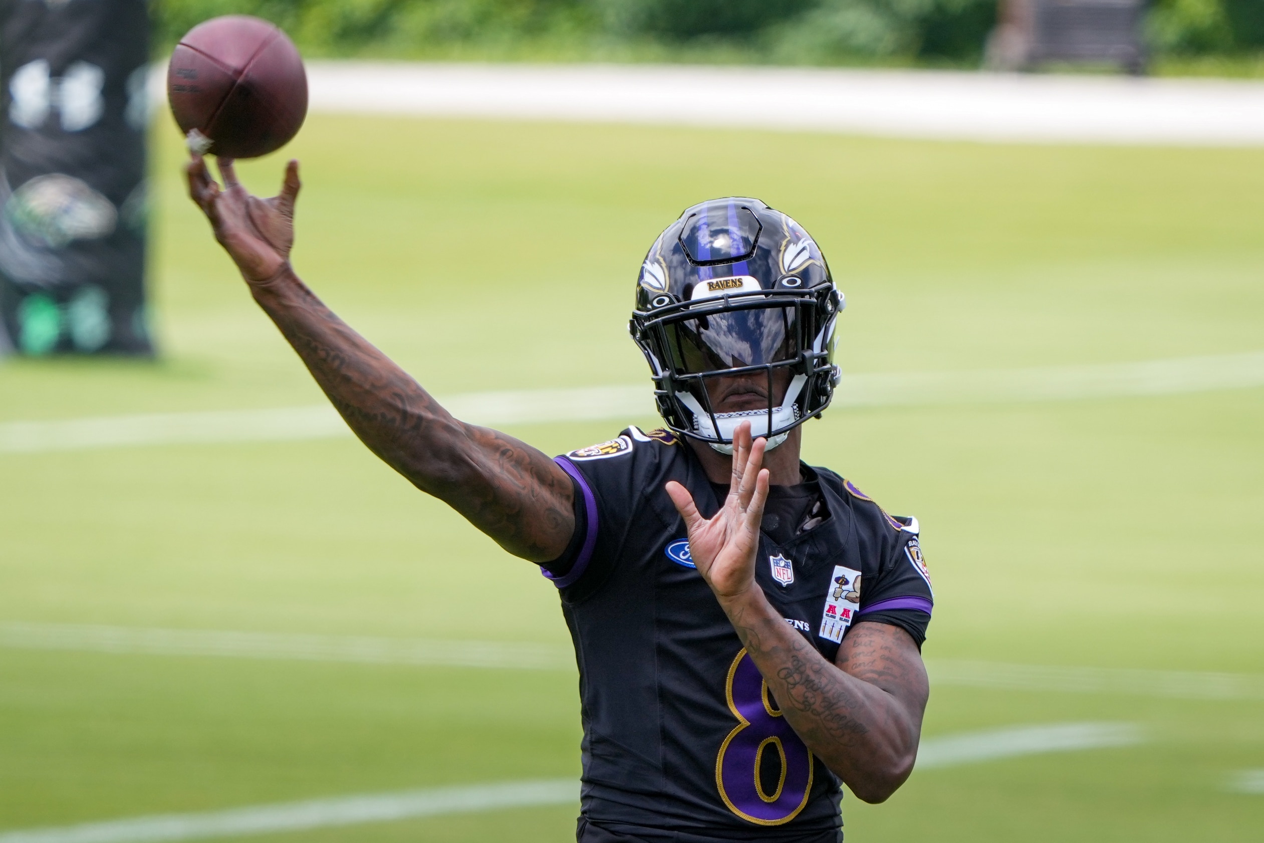 Lamar Jackson (8) throws a pass during mandatory minicamp on June 11. The quarterback had his most accurate passing day at training camp Tuesday.