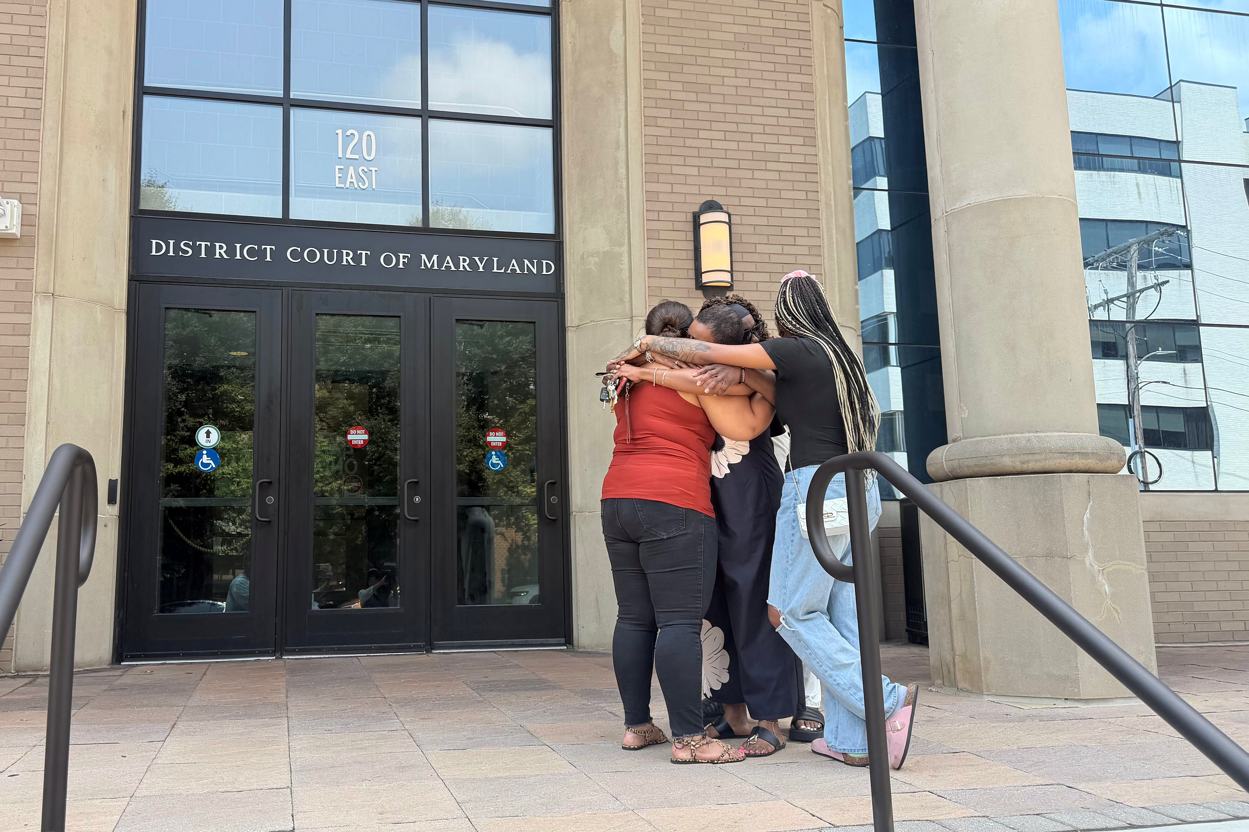 India Johnson’s relatives gather outside of the Maryland District Court courthouse in Towson on Wednesday after a bail review hearing.