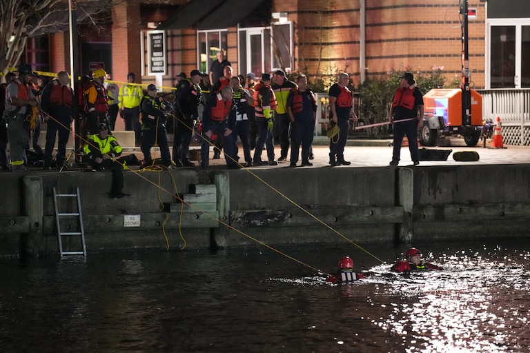 More than a dozen Baltimore fire trucks and police cars lined the area near the Pier 5 Pavilion on Tuesday, Nov. 18, 2025, as divers entered the water and rescue boats searched for the water.