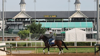 Horses train beneath the twin spires during morning workouts ahead of the running of the 152nd Kentucky Derby.