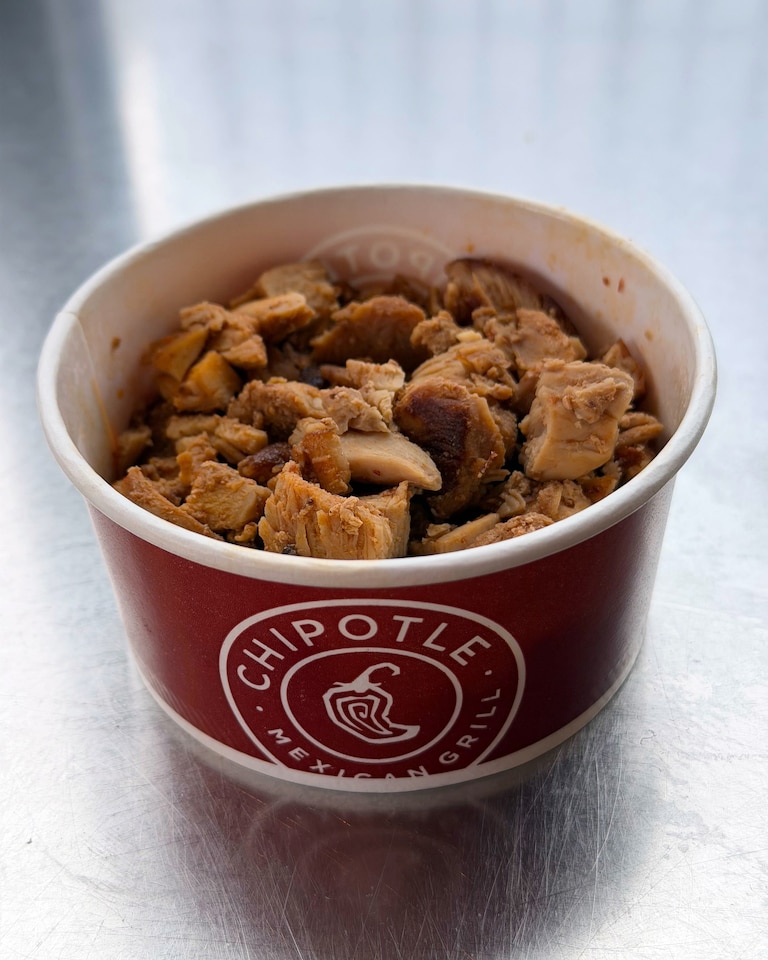 Chipotle unveiled its “first-ever high protein” menu on Dec. 23. One of the offerings is a snack-size cup of adobo chicken that has 32 grams of protein and looks like what you'd feed a dog for its birthday.