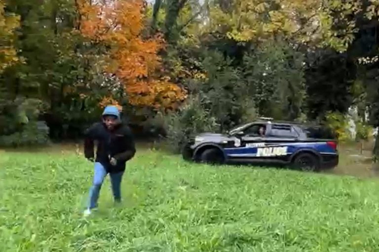 A screenshot from a video posted to social media shows Officer Robert A. Parks chasing a man who was on foot by driving after him in a police vehicle.