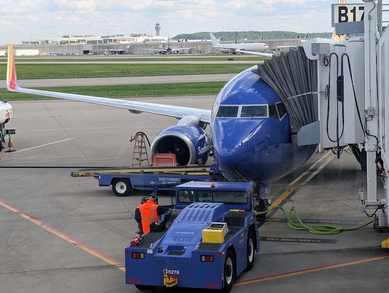 A Southwest Airlines flight sits next to the passenger gate as passengers in Louisville, Kentucky, board for a flight to Baltimore-Washington International Airport.