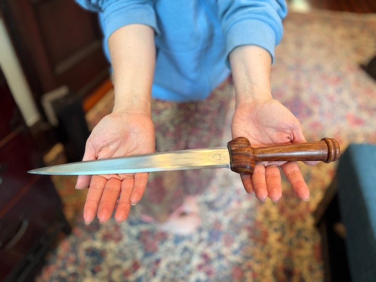 Rachel Cooper used a decorative knife that was hanging on the wall of her Bolton Hill home to fight off an intruder early Friday, May 8. Cooper holds the knife in her kitchen as she describes the attack on Sunday, May 10.
