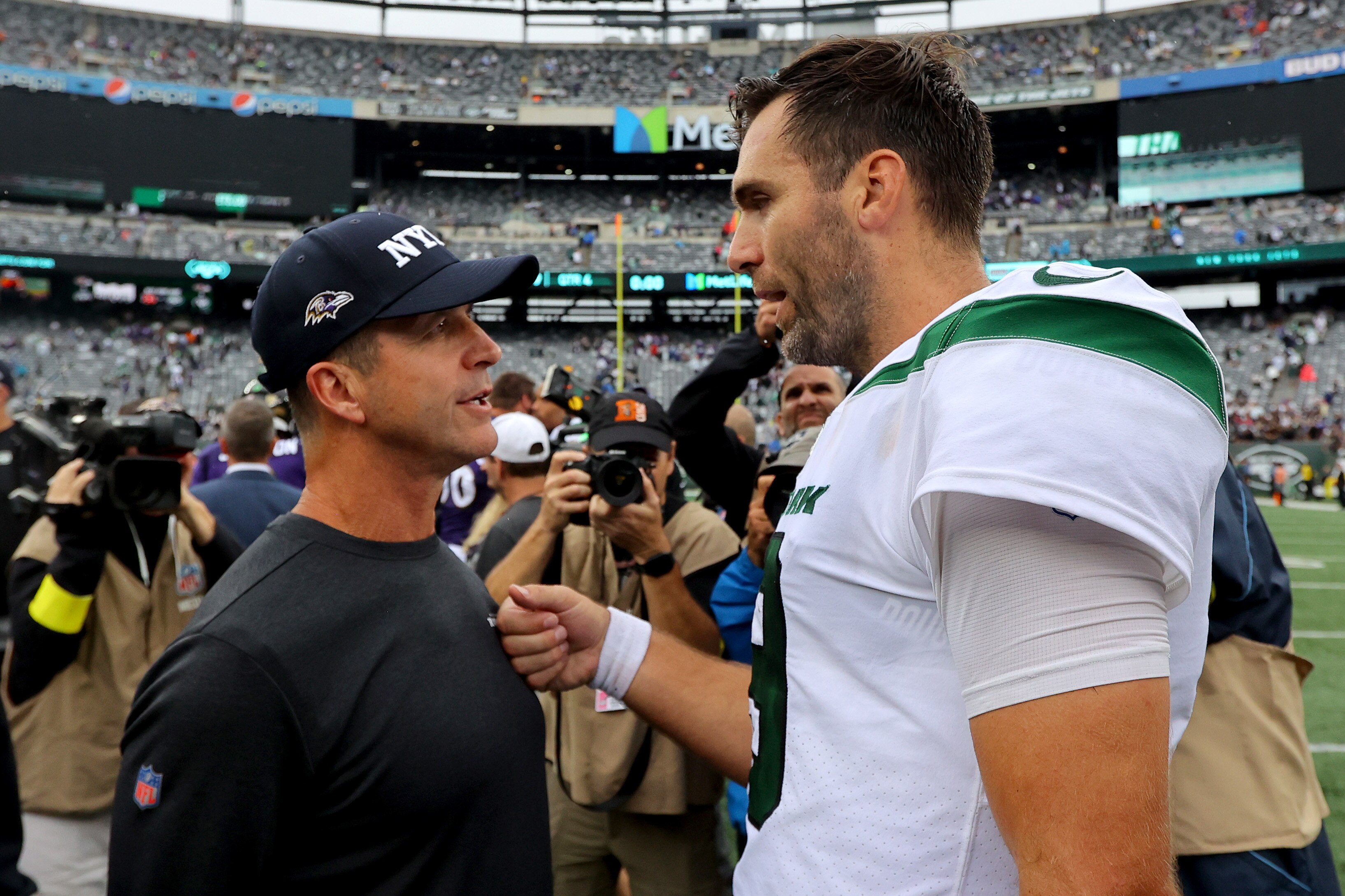 EAST RUTHERFORD, NEW JERSEY - SEPTEMBER 11: Head Coach John Harbaugh of the Baltimore Ravens talks with Quarterback Joe Flacco #19 of the New York Jets after defeating the New York Jets 24-9 at MetLife Stadium on September 11, 2022 in East Rutherford, New Jersey. (Photo by Mike Stobe/Getty Images)