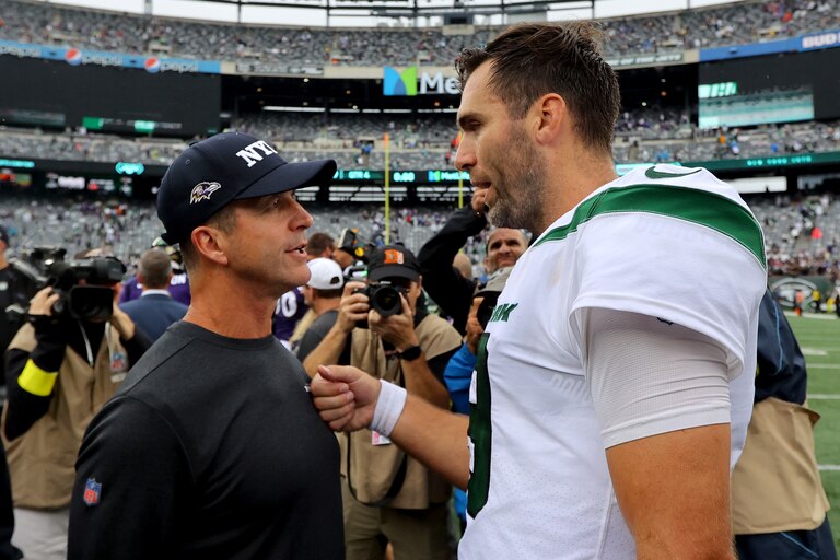 EAST RUTHERFORD, NEW JERSEY - SEPTEMBER 11: Head Coach John Harbaugh of the Baltimore Ravens talks with Quarterback Joe Flacco #19 of the New York Jets after defeating the New York Jets 24-9 at MetLife Stadium on September 11, 2022 in East Rutherford, New Jersey. (Photo by Mike Stobe/Getty Images)