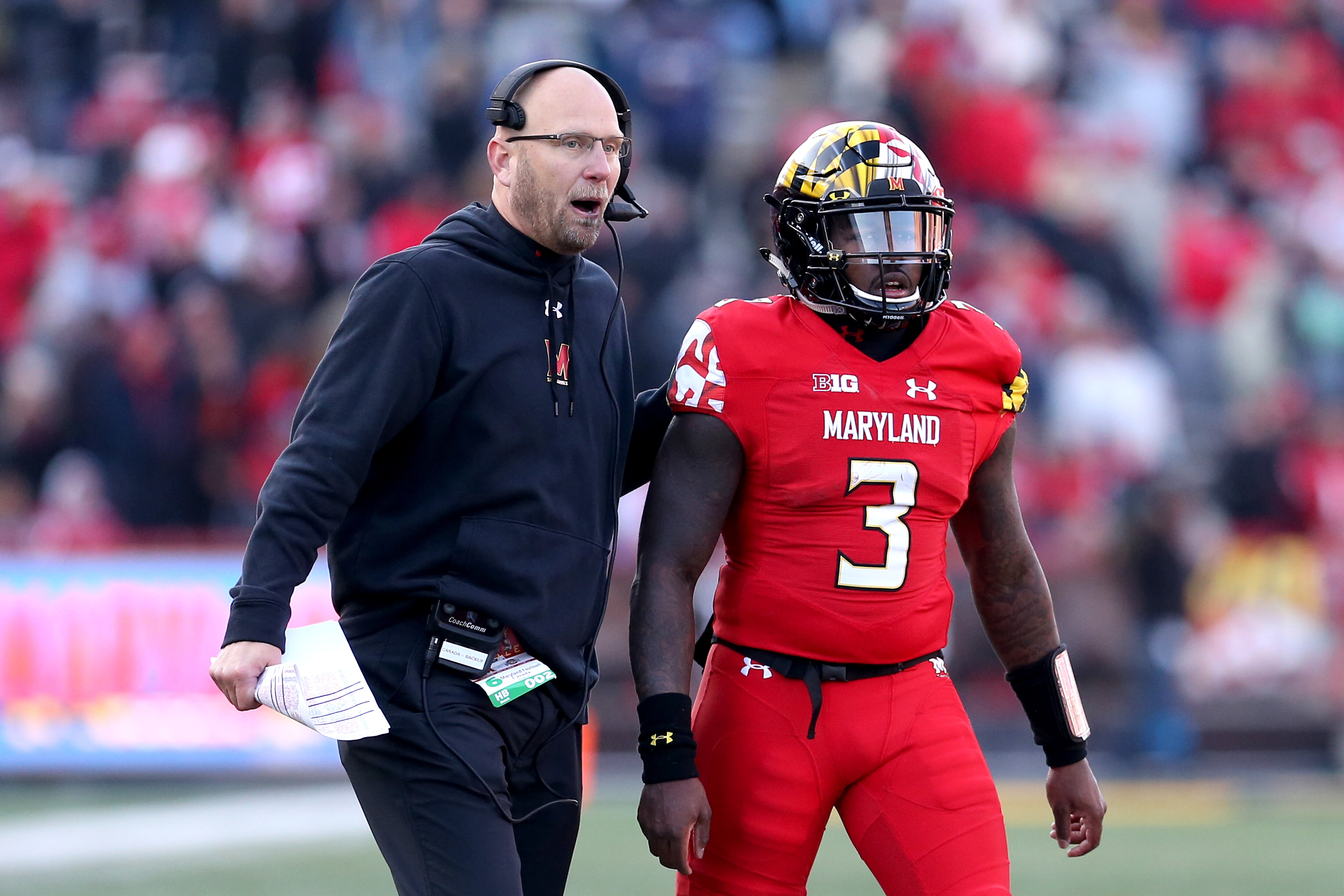 Interim head coach Matt Canada speaks to quarterback Tyrrell Pigrome during the second half of Maryland's 2018 game against Ohio State.