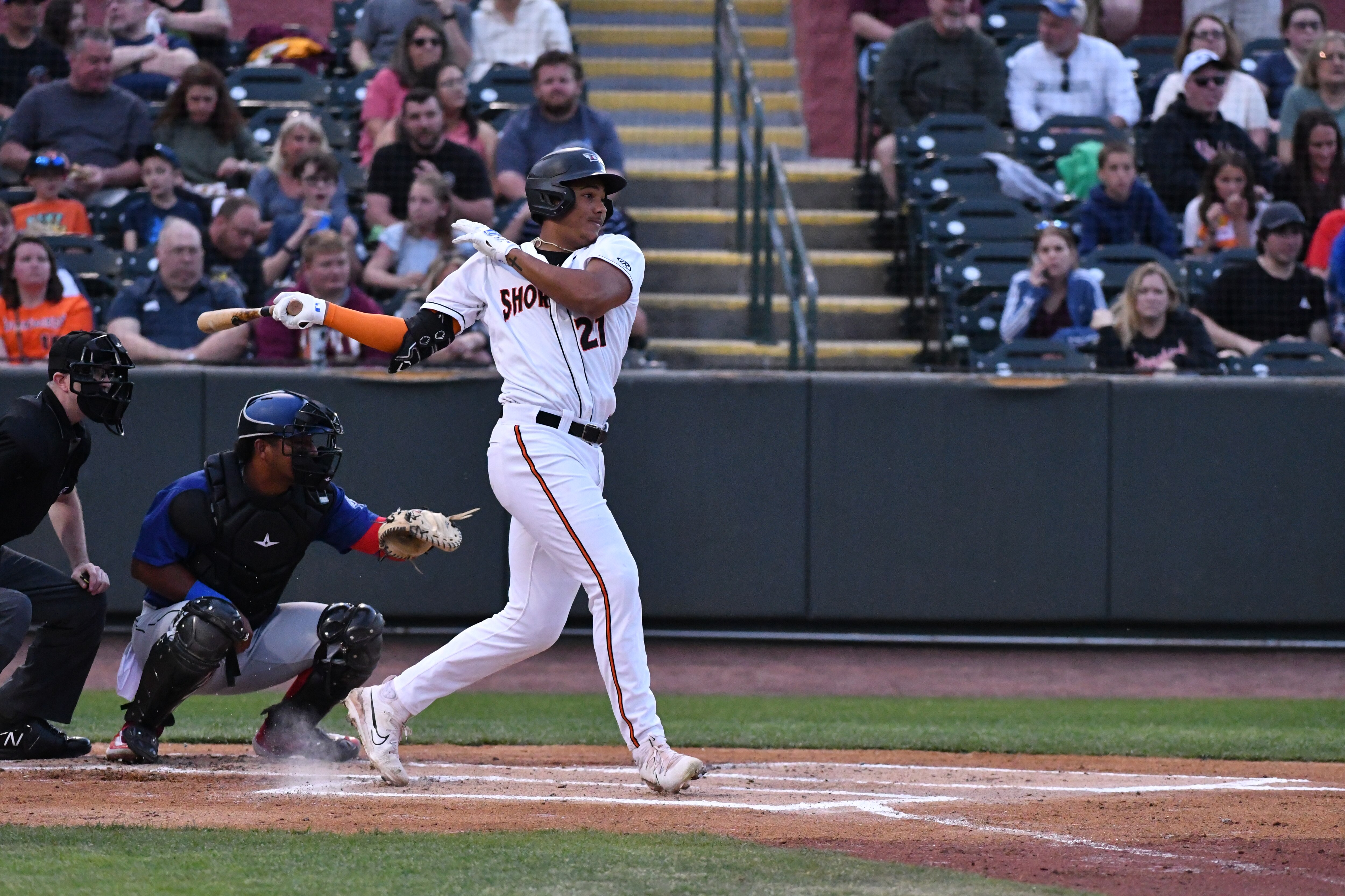 This photo shows a left-handed baseball player finishing his swing.