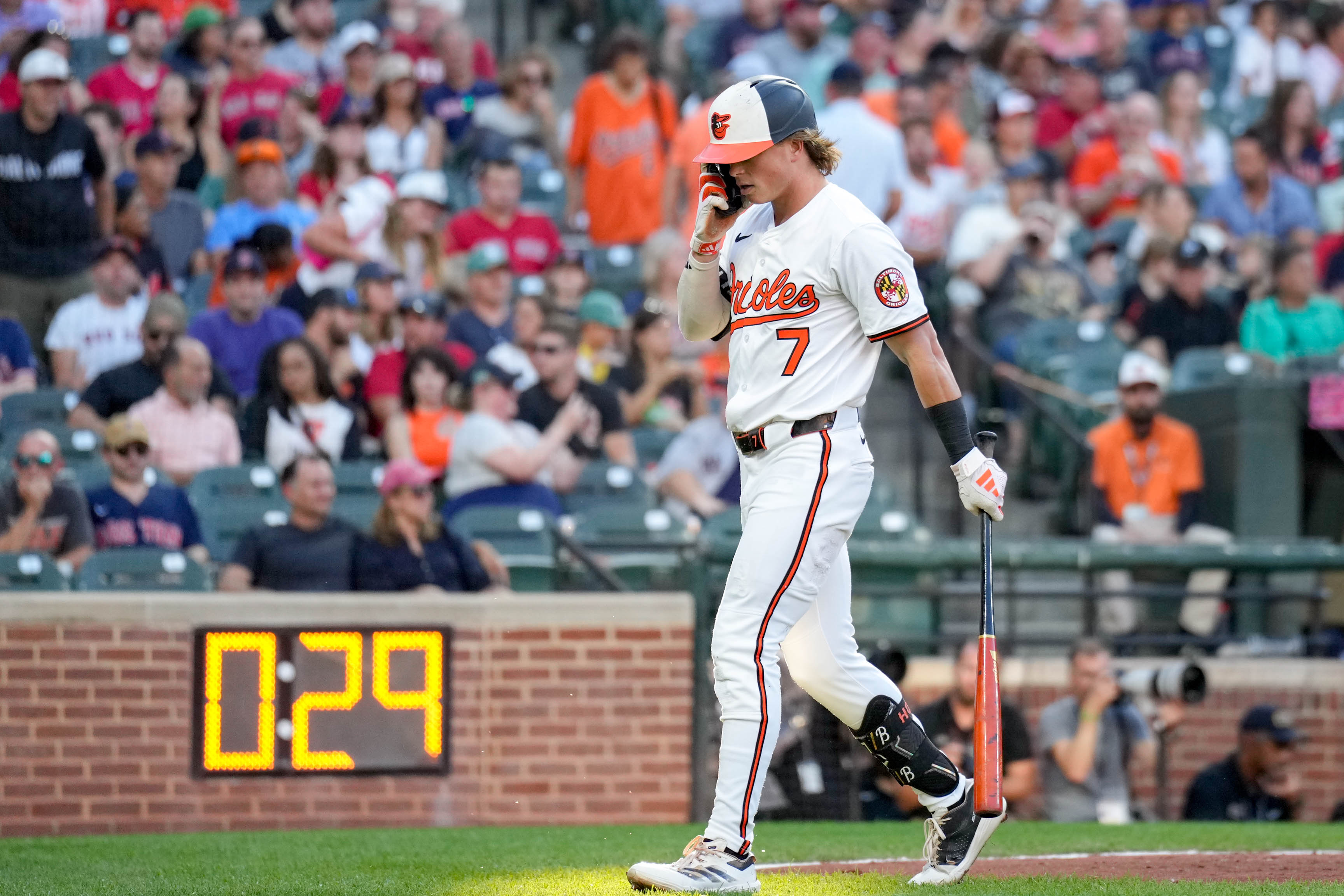 Orioles second baseman Jackson Holliday returns to the dugout after striking out in the first inning against the Boston Red Sox on Aug. 25.