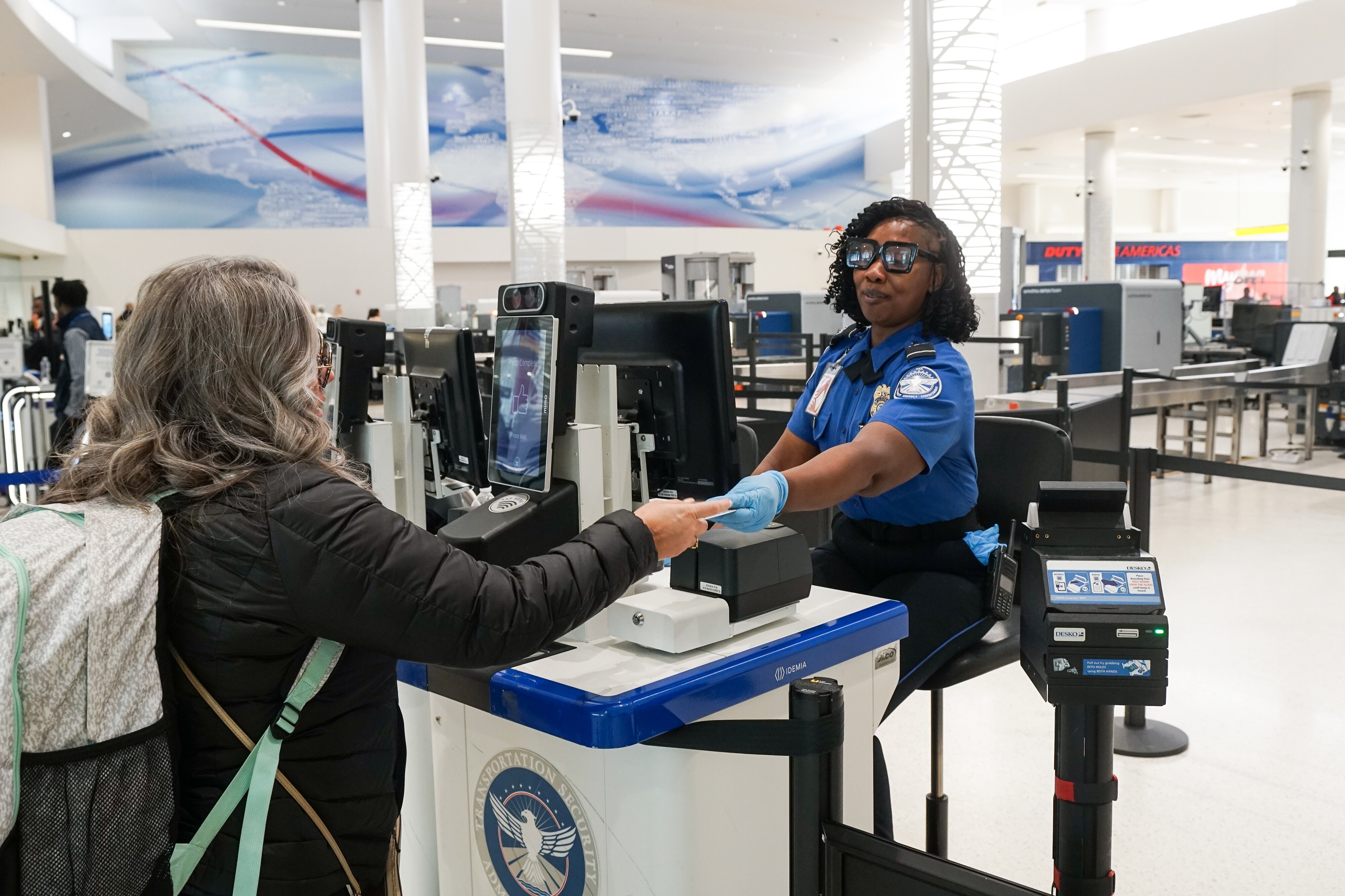 Cornia Lemon of the Transportation Security Administration checks a traveler's identification at BWI Airport on Jan. 23.