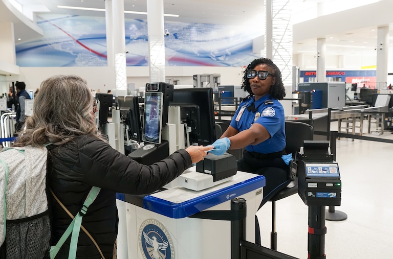 Cornia Lemon of the Transportation Security Administration checks a traveler's identification at BWI Airport on Jan. 23.
