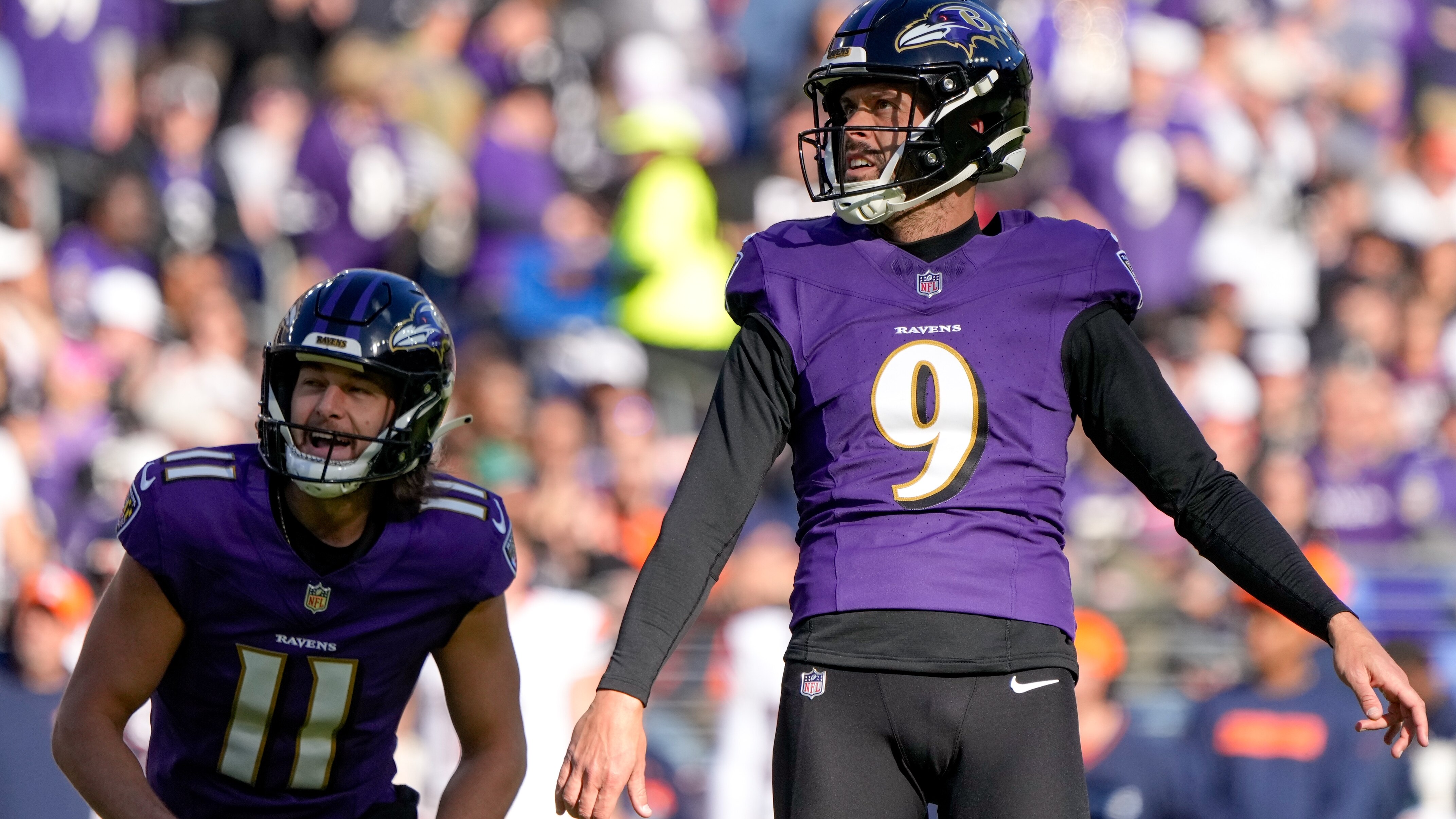 Baltimore Ravens punter Jordan Stout (11) and Baltimore Ravens place kicker Justin Tucker (9) watch as his extra point sails through the uprights in a regular season game against the Denver Broncos at M&T Bank Stadium on Sunday, November 3, 2024.