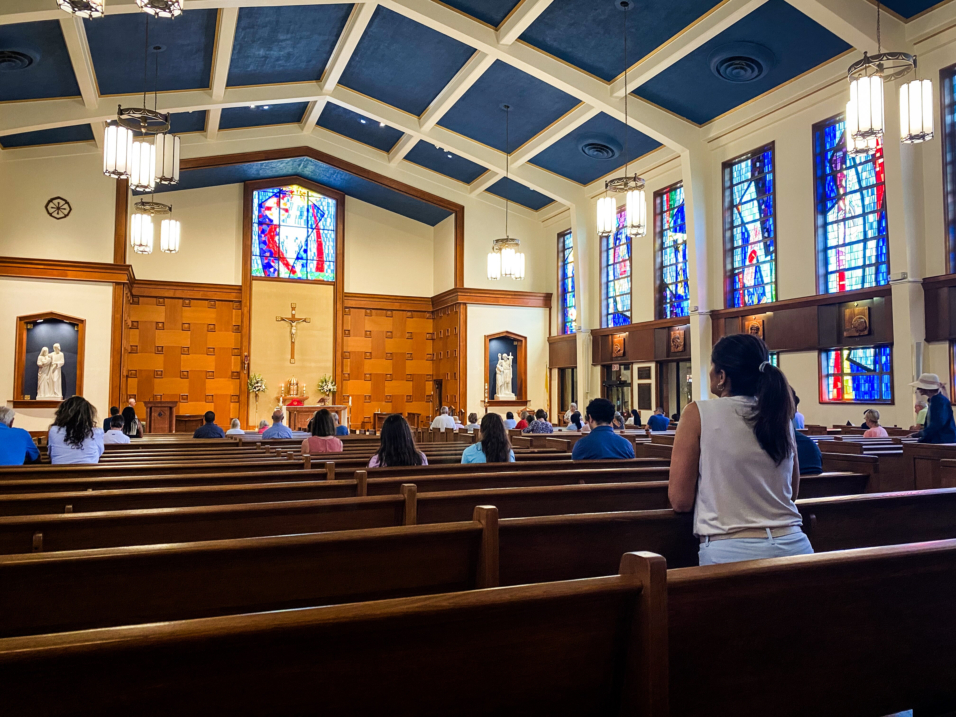 Parishioners pray before Mass at Our Lady of Lourdes in Bethesda on Aug. 14, 2024.