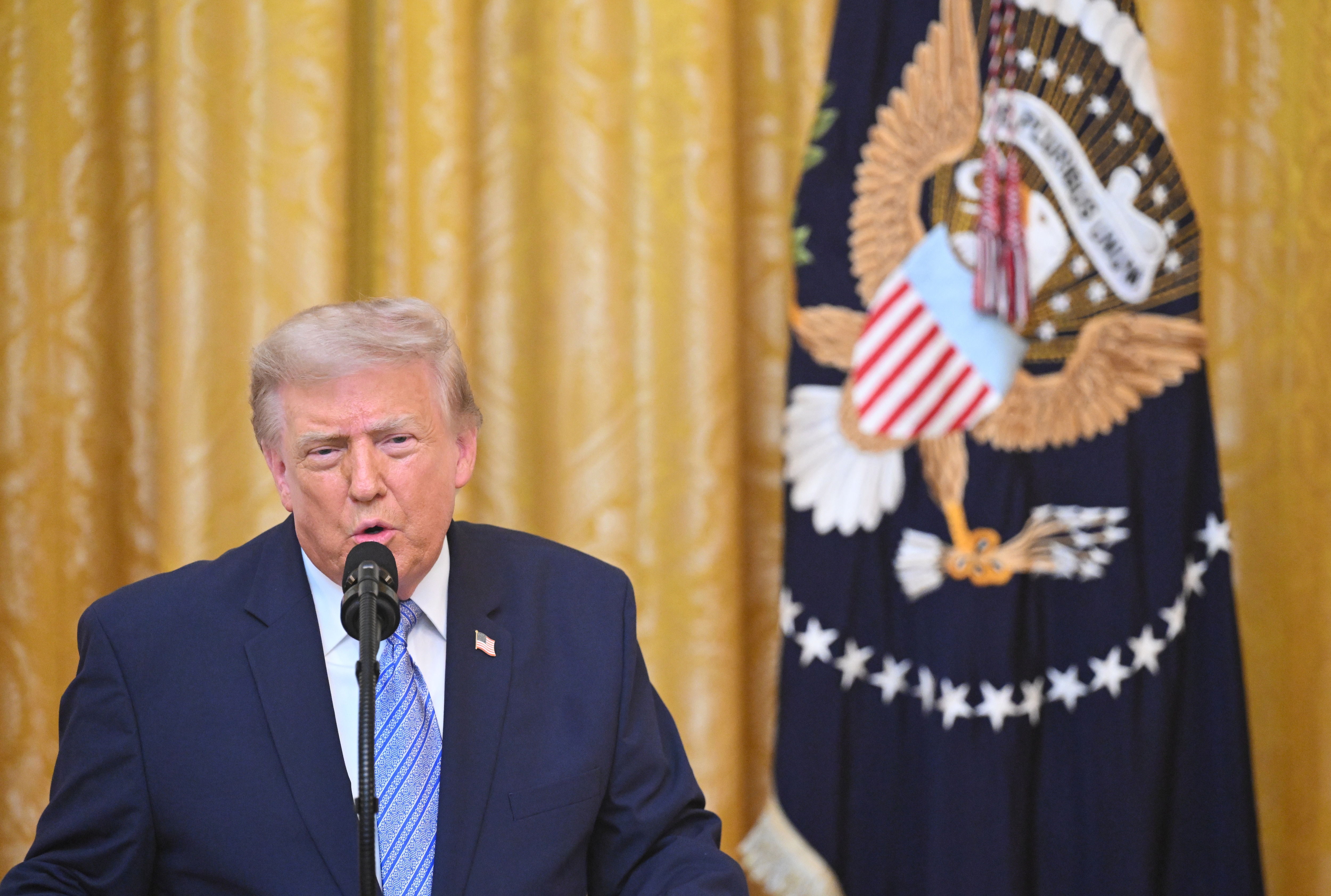 President Donald Trump speaks Thursday night in the East Room of the White House in Washington.