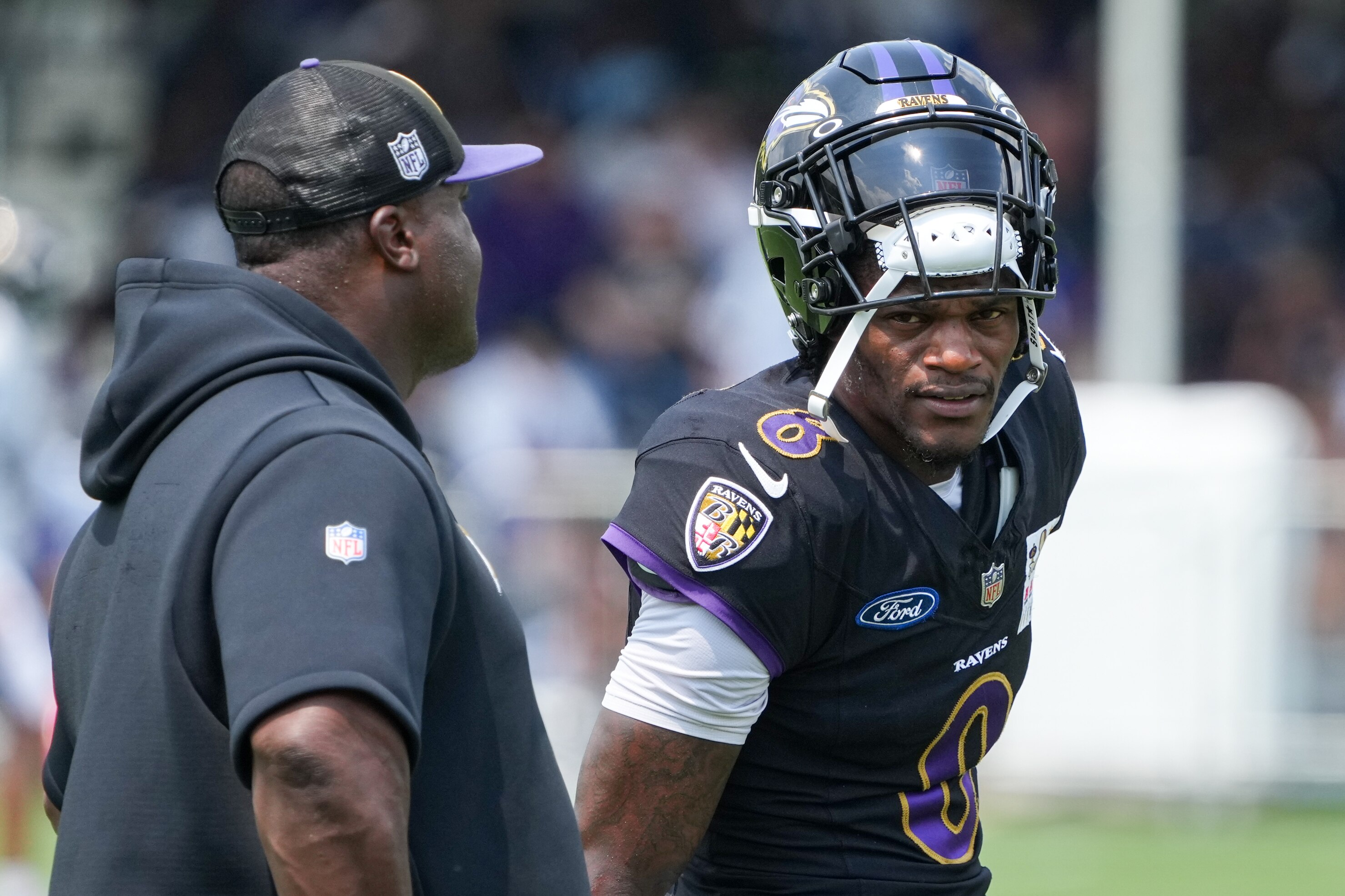 Quarterback Lamar Jackson (8) takes a break between drills on Aug. 6.