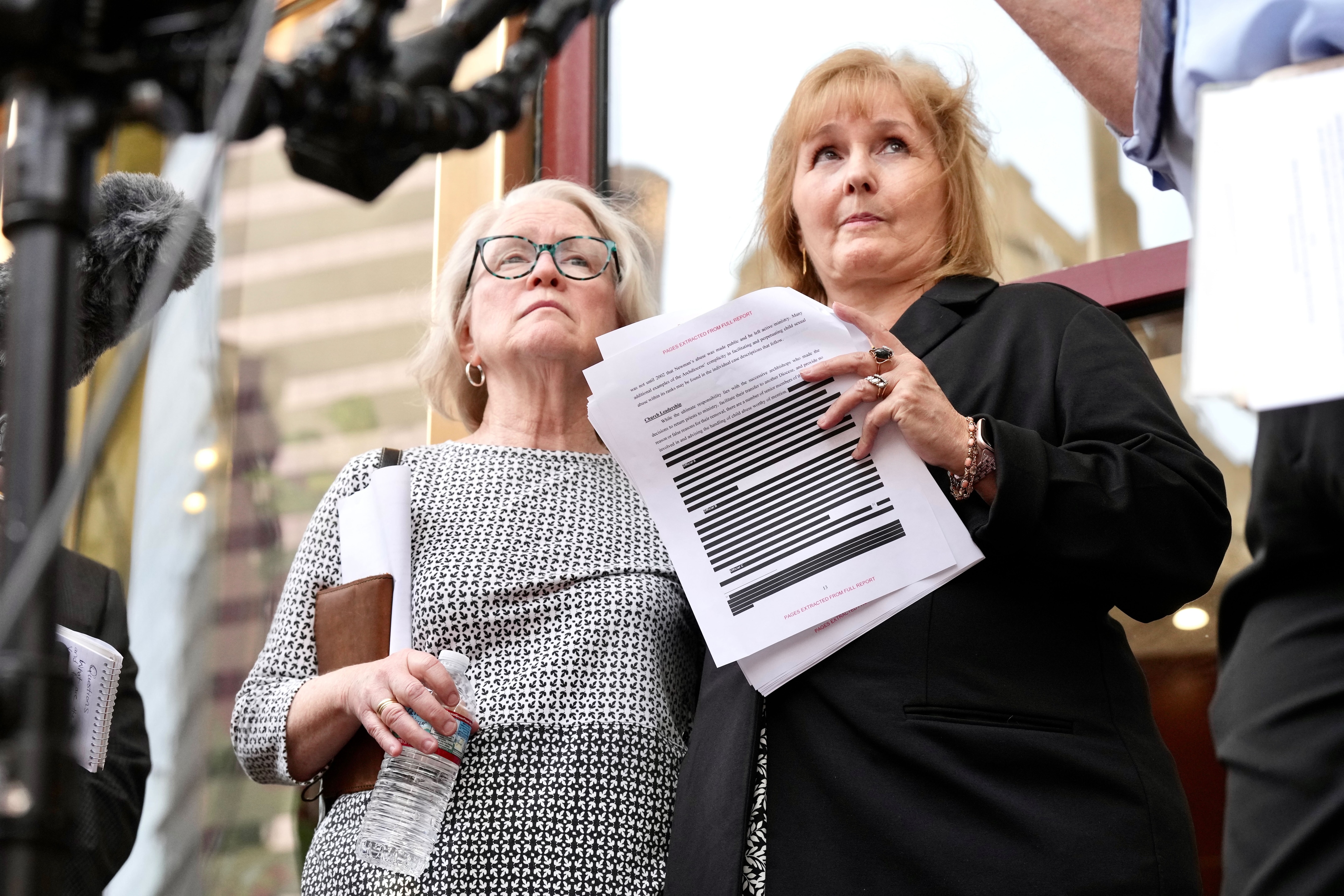 The Attorney General’s office released the Catholic Church Investigation papers.  Jean Hargadon (glasses) Teresa Lancaster,  holds a redacted copy of the release.