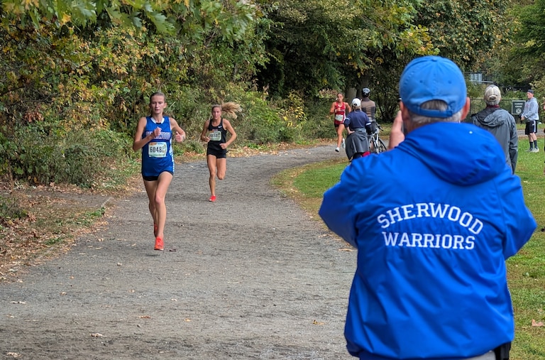 Dan Reeks coaches Madeline Quirion during the Manhattan University Cross Country Invitation on Oct. 11.