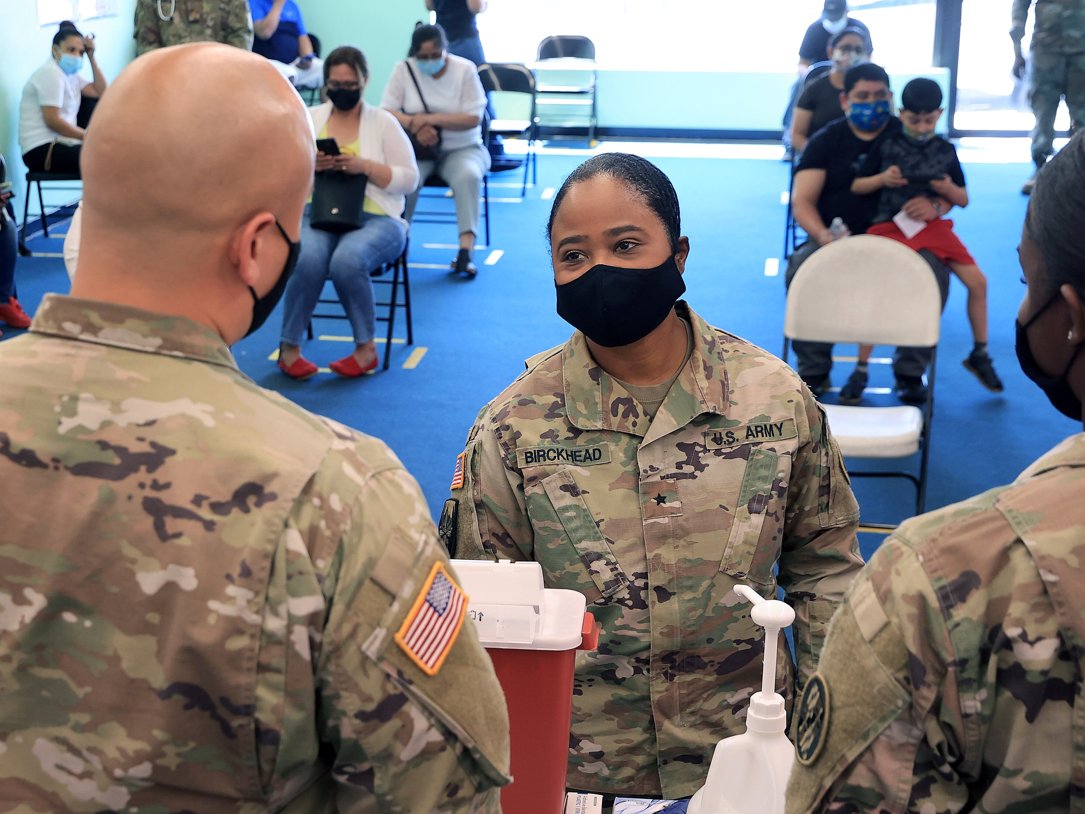 WHEATON, MARYLAND - MAY 21: Maryland National Guard Brigadier General Janeen Birckhead (C) receives an update from Sgt. Jason Grant (L) and Cadet Dashanae Harper during a mobile coronavirus vaccine clinic at CASA de Maryland's Wheaton Welcome Center on May 21, 2021 in Wheaton, Maryland. The was part of the Maryland Vaccine Equity Task Force, which works with local health departments and community organizations to focus COVID-19 vaccination efforts on "underserved, vulnerable, and hard-to-reach populations."