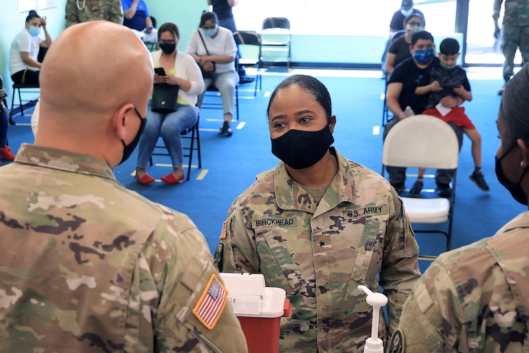 WHEATON, MARYLAND - MAY 21: Maryland National Guard Brigadier General Janeen Birckhead (C) receives an update from Sgt. Jason Grant (L) and Cadet Dashanae Harper during a mobile coronavirus vaccine clinic at CASA de Maryland's Wheaton Welcome Center on May 21, 2021 in Wheaton, Maryland. The was part of the Maryland Vaccine Equity Task Force, which works with local health departments and community organizations to focus COVID-19 vaccination efforts on "underserved, vulnerable, and hard-to-reach populations."