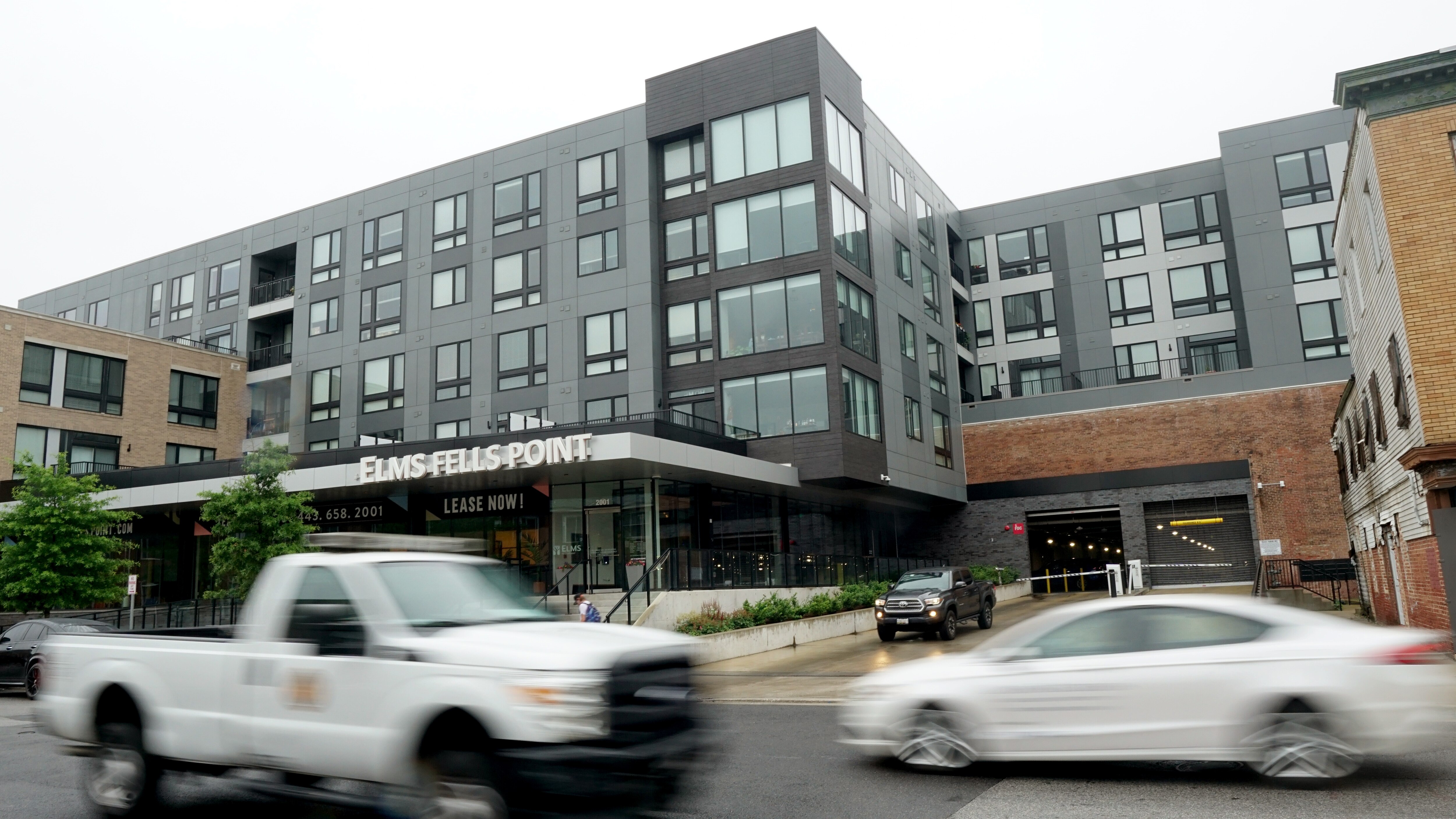 A car pulls out of a Fells Point apartment complex on June 16, 2025. A proposed bill before Baltimore City Council would eliminate the requirement that many new housing and retail developments provide off-street parking like garages.