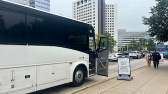 Metro commuters walk to a shuttle bus outside the North Bethesda Metro station.