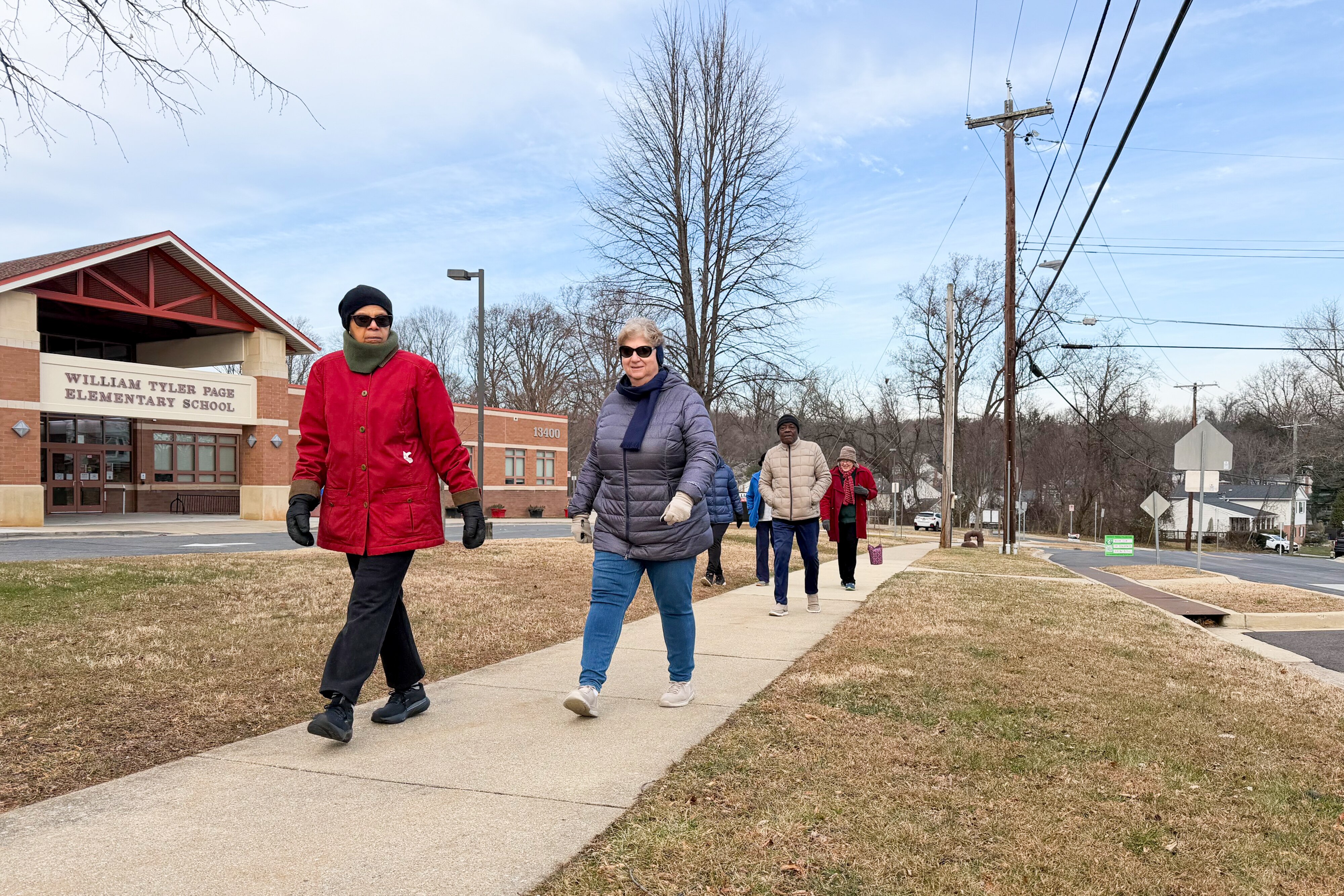 Longtime Tamarack Triangle residents Robyn De Shields and Diane Straud lead out the weekend walking club, which met in front of Page Elementary School on a cold Saturday morning.