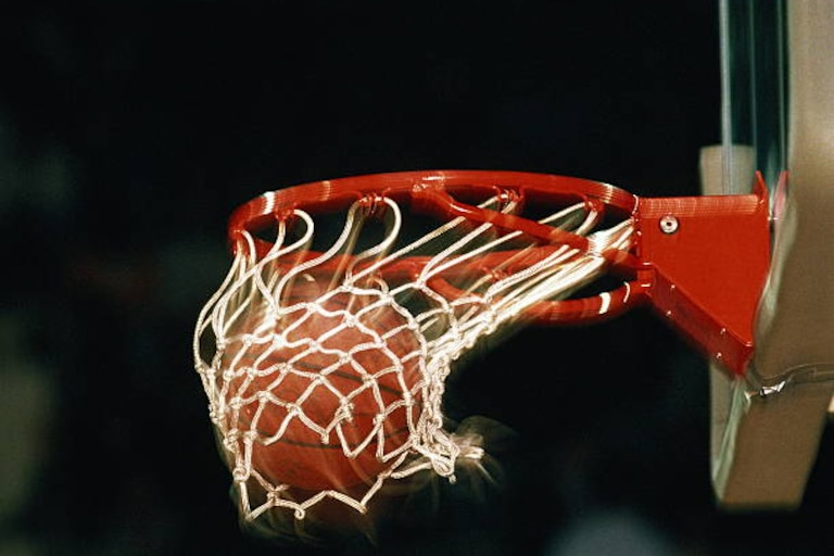 A basketball in a basketball hoop.