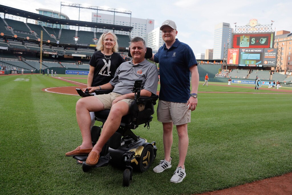 FILE - Former Baltimore Orioles pitcher Jim Poole, center, poses for a photo with his wife, Kim Poole, left, and their son Hayden Poole, prior to a baseball game between the Orioles and the Seattle Mariners, Thursday, June 2, 2022, in Baltimore. Poole, who pitched in the big leagues for 11 seasons and surrendered the deciding homer to Atlanta's David Justice in the 1995 World Series, died of complications from ALS, Friday, Oct. 6, 2023. He was 57.