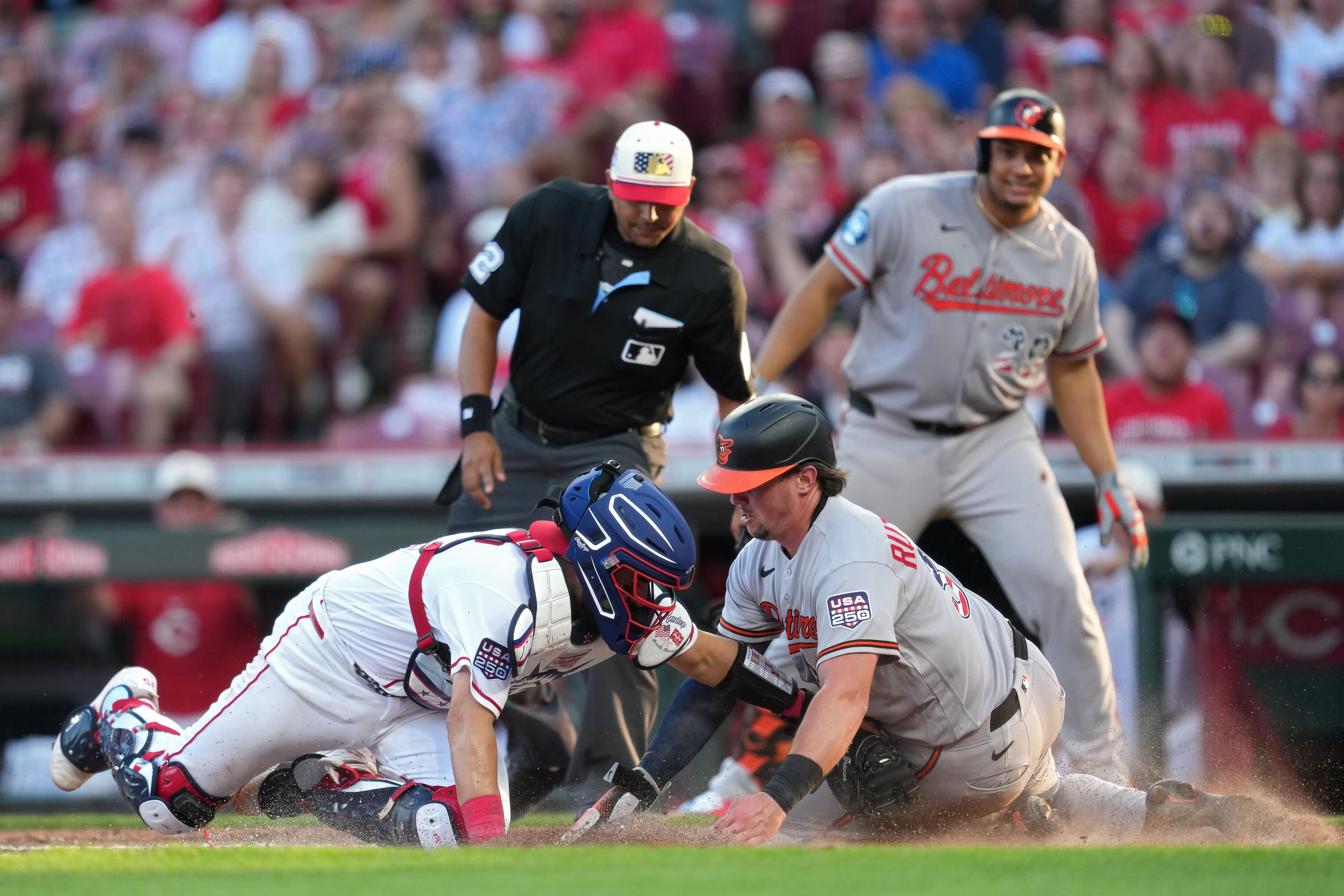 Reds catcher Jose Trevino tags out Adley Rutschman trying to score on a single by Pete Alonso during the third inning Saturday night in Cincinnati.