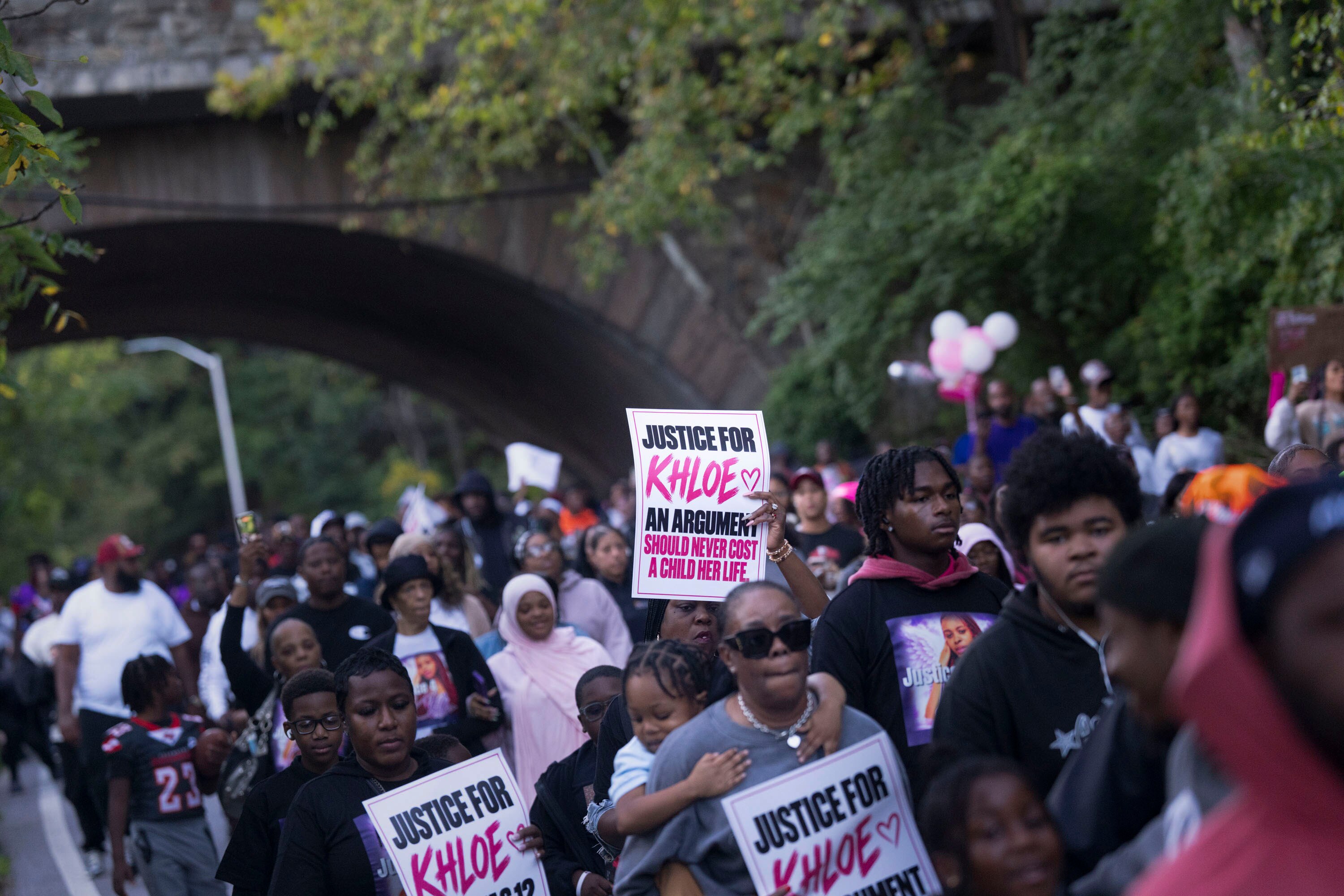 Community members gather for a peace walk and vigil in memory of Khloe Ishway, a 12-year-old who was killed in a mass shooting in Franklintown during a homecoming youth football game. 