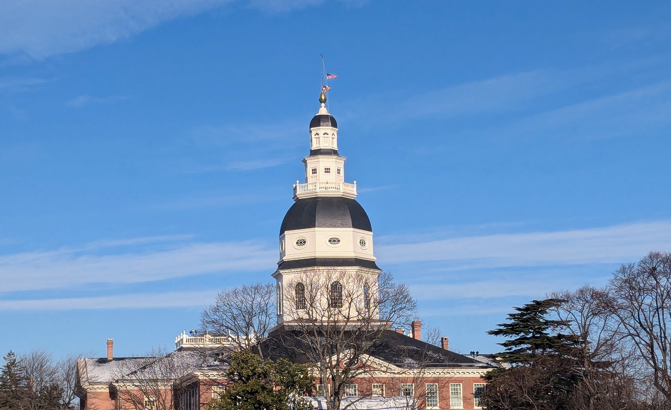 The U.S. and Maryland flags fly at half staff on Jan. 20, 2025, hours before the inauguration of Donald Trump as the 47th president of the United States, to honor Jimmy Carter, the 39th.
