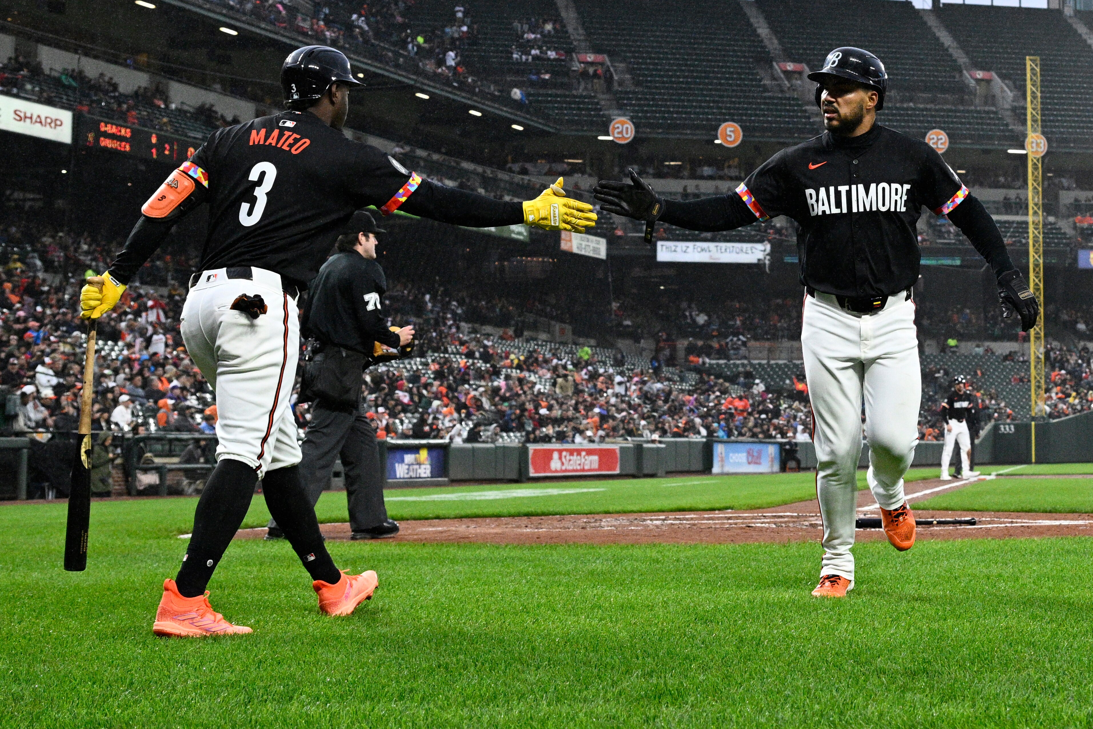 Orioles outfielder Anthony Santander is greeted by Jorge Mateo after scoring on a groundout during the second inning.
