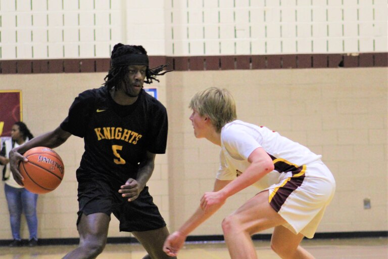 Parkville's Caron Smith is defended by Hereford's Sam Nicholson during Friday's Baltimore County boys basketball contest. Smith scored a game-high 18 points as the No. 3 Knights remained undefeated with a 64-40 victory over the 14th-ranked Bulls in Parkton.