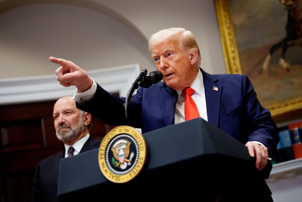 U.S. President Donald Trump, accompanied by Commerce Secretary Howard Lutnick (L) takes a question from a reporter in the Roosevelt Room of the White House on March 3, 2025
