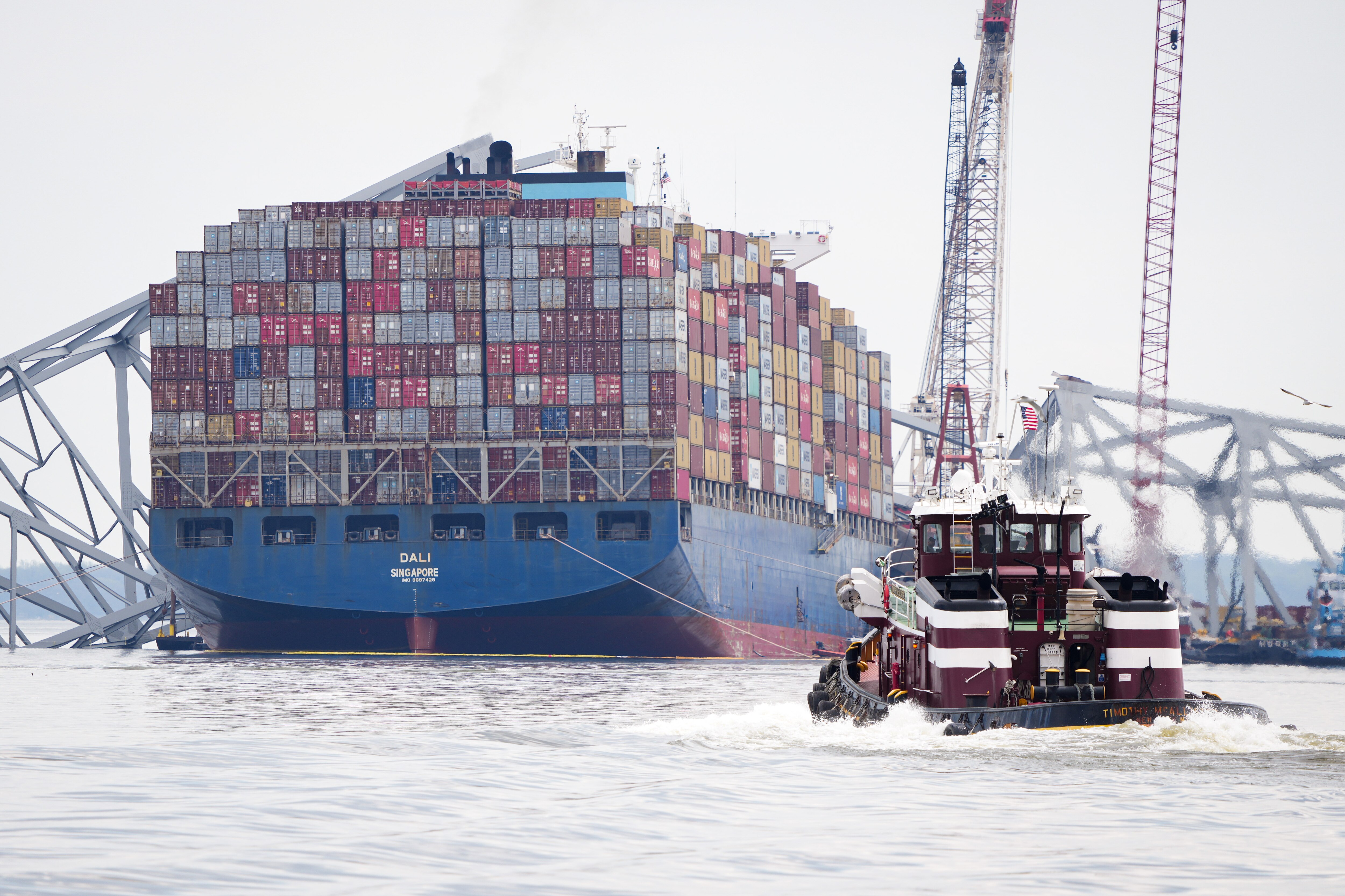 The Dali cargo ship and the collapsed Francis Scott Key Bridge are seen from a Department of Natural Resources boat on the Patapsco River in Baltimore, on April 10, 2024.