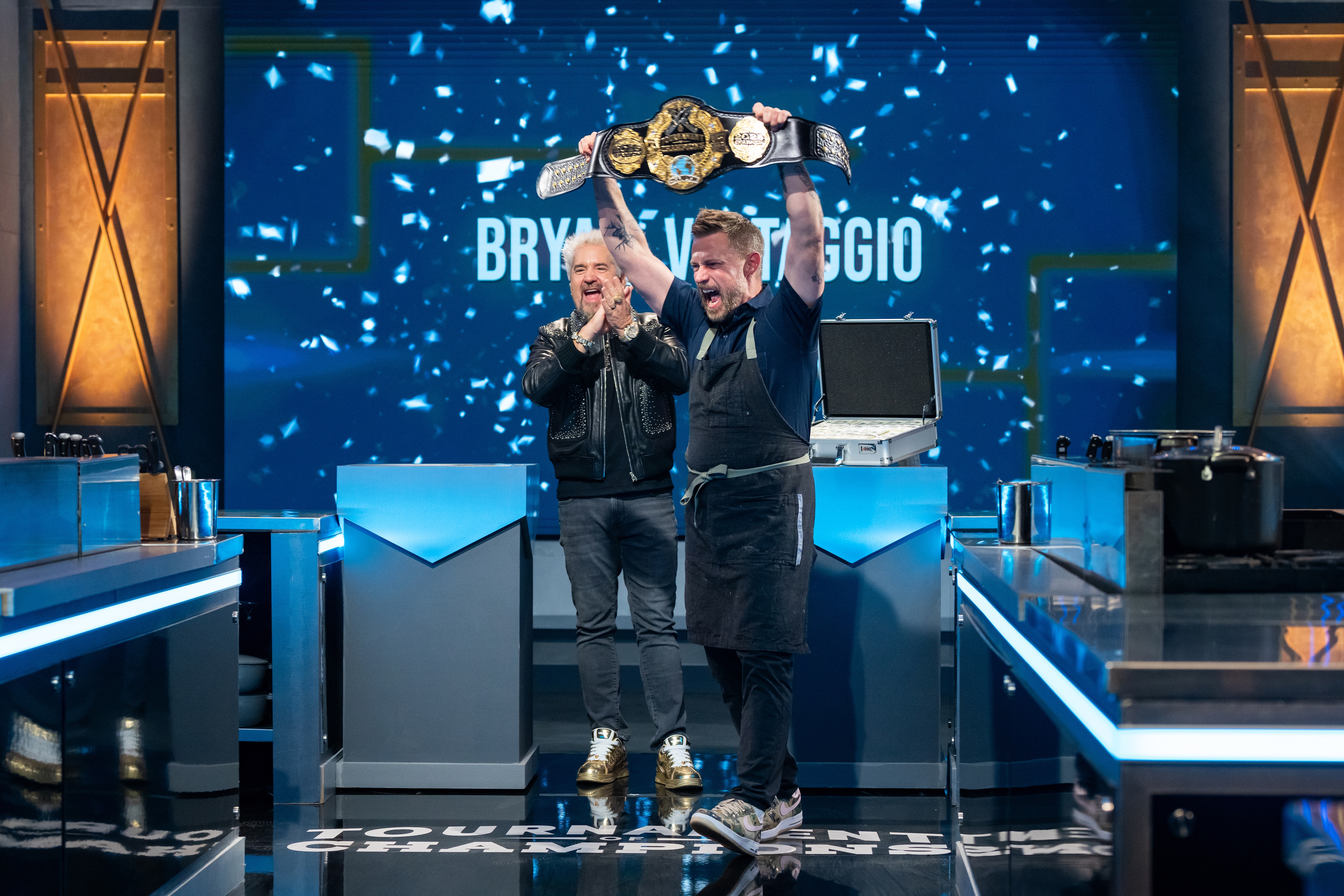 Host Guy Fieri and contestant Bryan Voltaggio reacts as he is announced the Tournament of Champions, Season 7 winner, as seen on Tournament of Champions, Season 7.