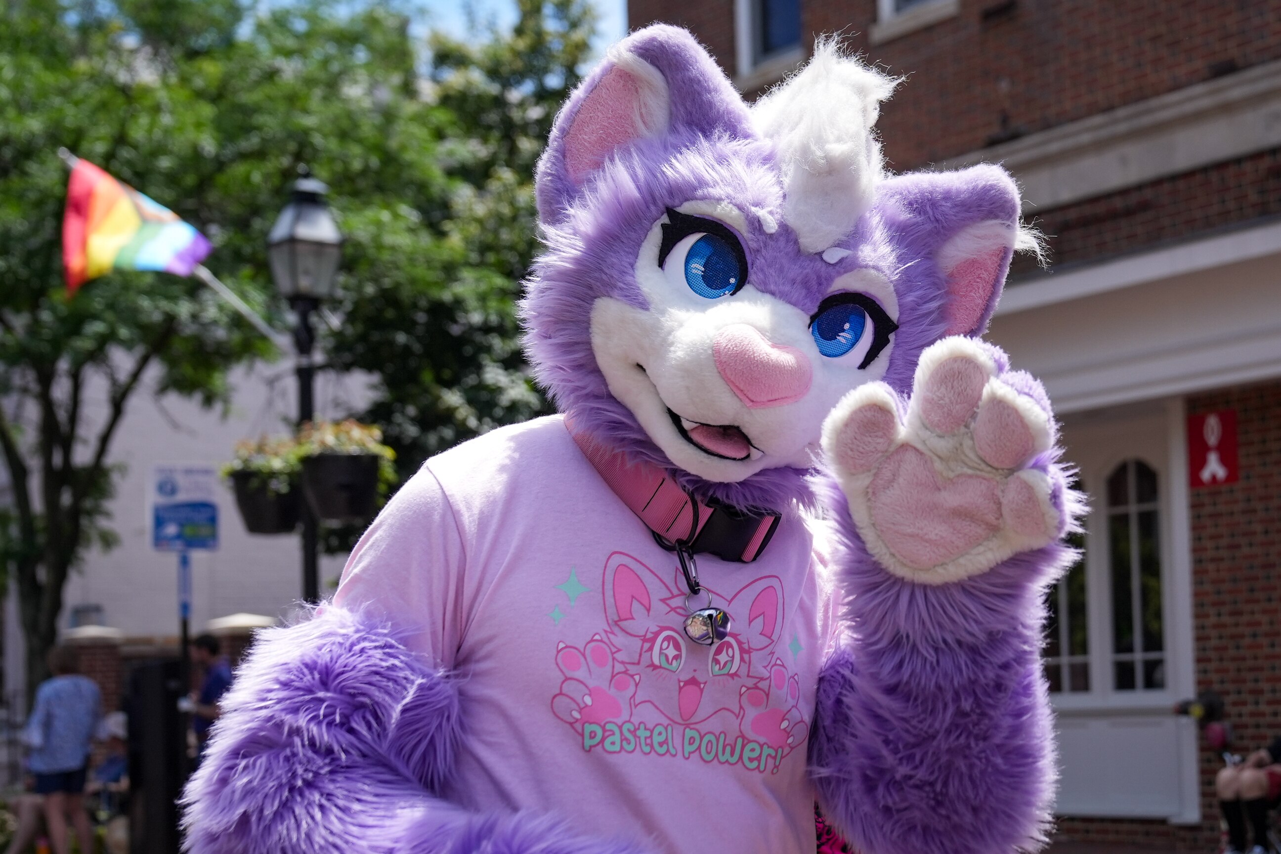 A person dressed in an animal costume waves to people along West Street during the Annapolis Pride Parade and Festival on June 1, 2024.