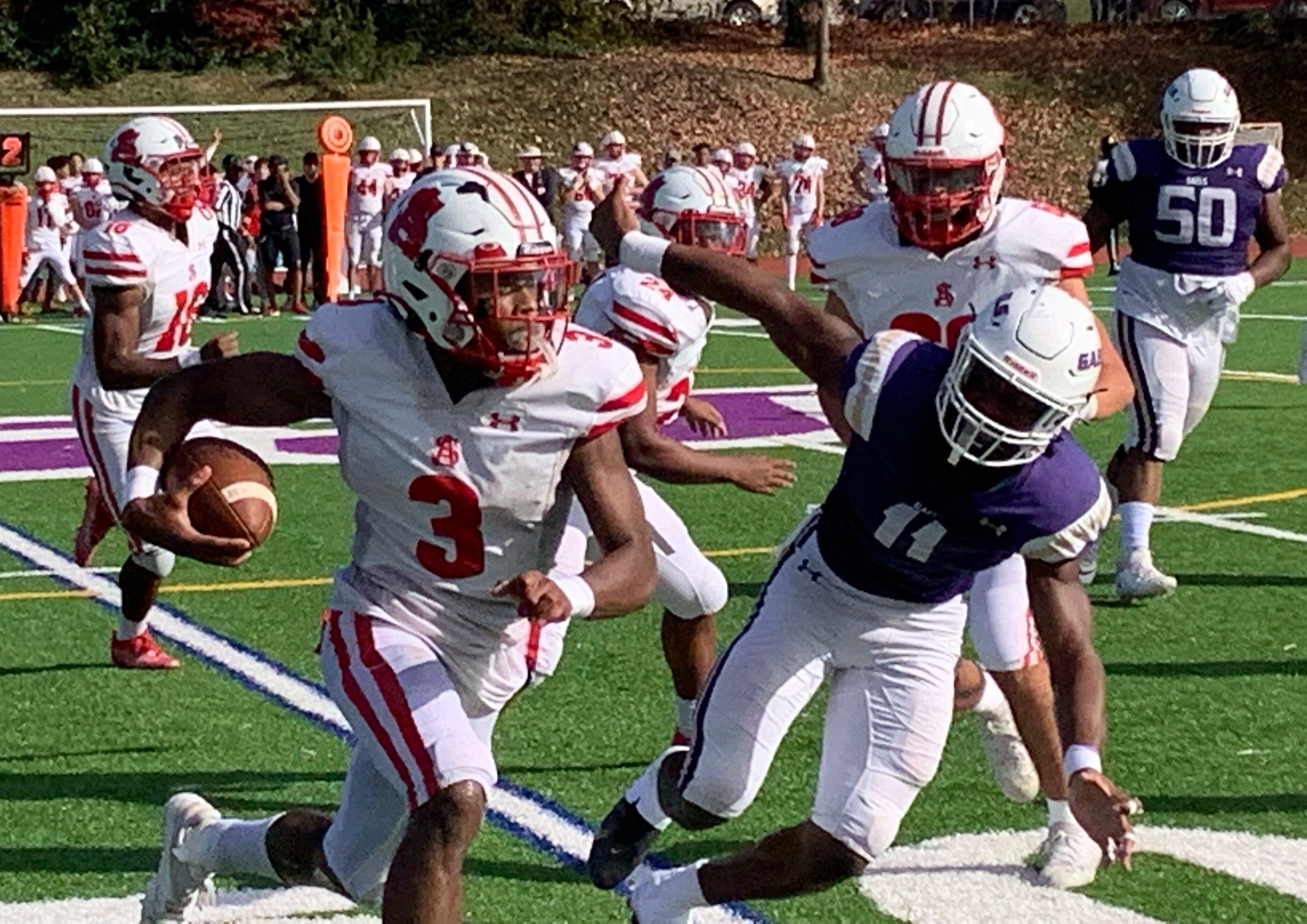 Spalding's Tyler Brown heads upfield, with Mount St. Joseph's Sahir West in pursuit, after intercepting a pass during Saturday's MIAA A Conference football game. The No. 2 Cavaliers completed a second straight regular season in league play with a 35-21 decision over the third-ranked Gaels in Baltimore City.