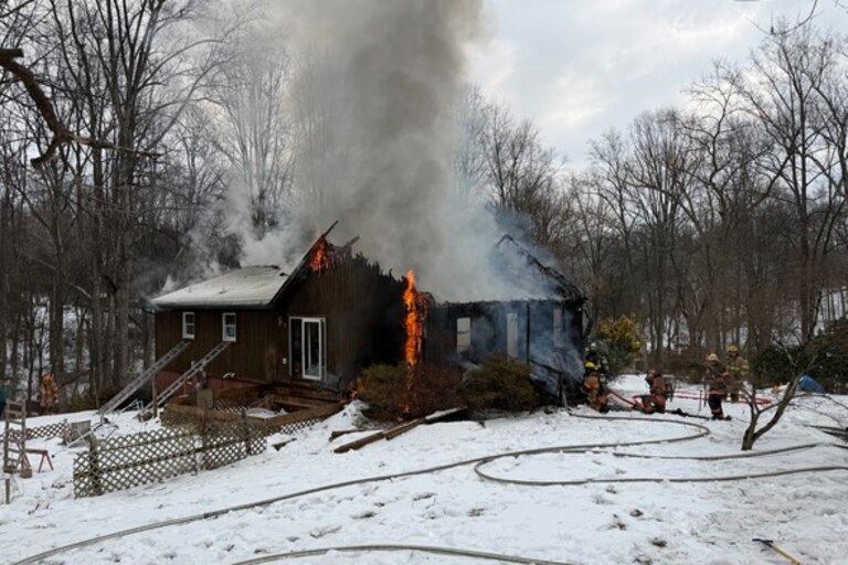 Heavy smoke and flames pour out of a house in Bel Air.