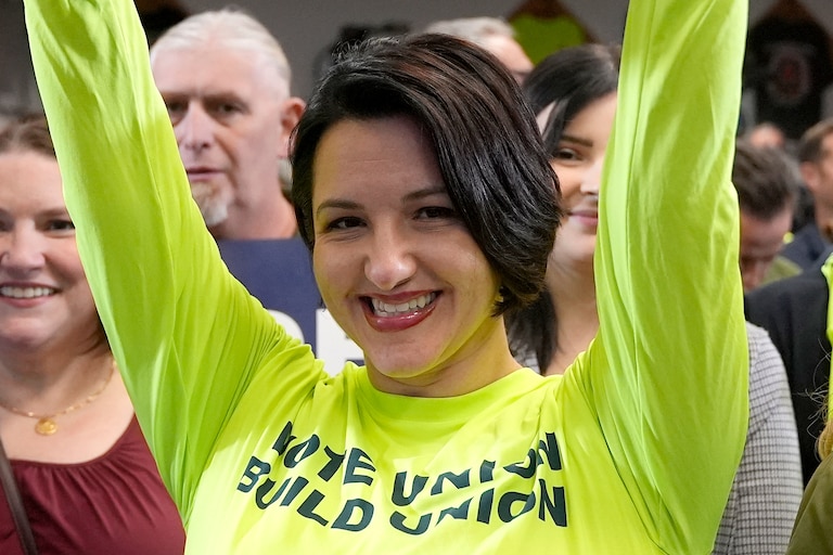 Natasha Guynes holds up a sign as she waits for President Joe Biden to speak to labor union members at Carpenters Local 445, in Scranton, Pa., Saturday, Nov. 2, 2024.