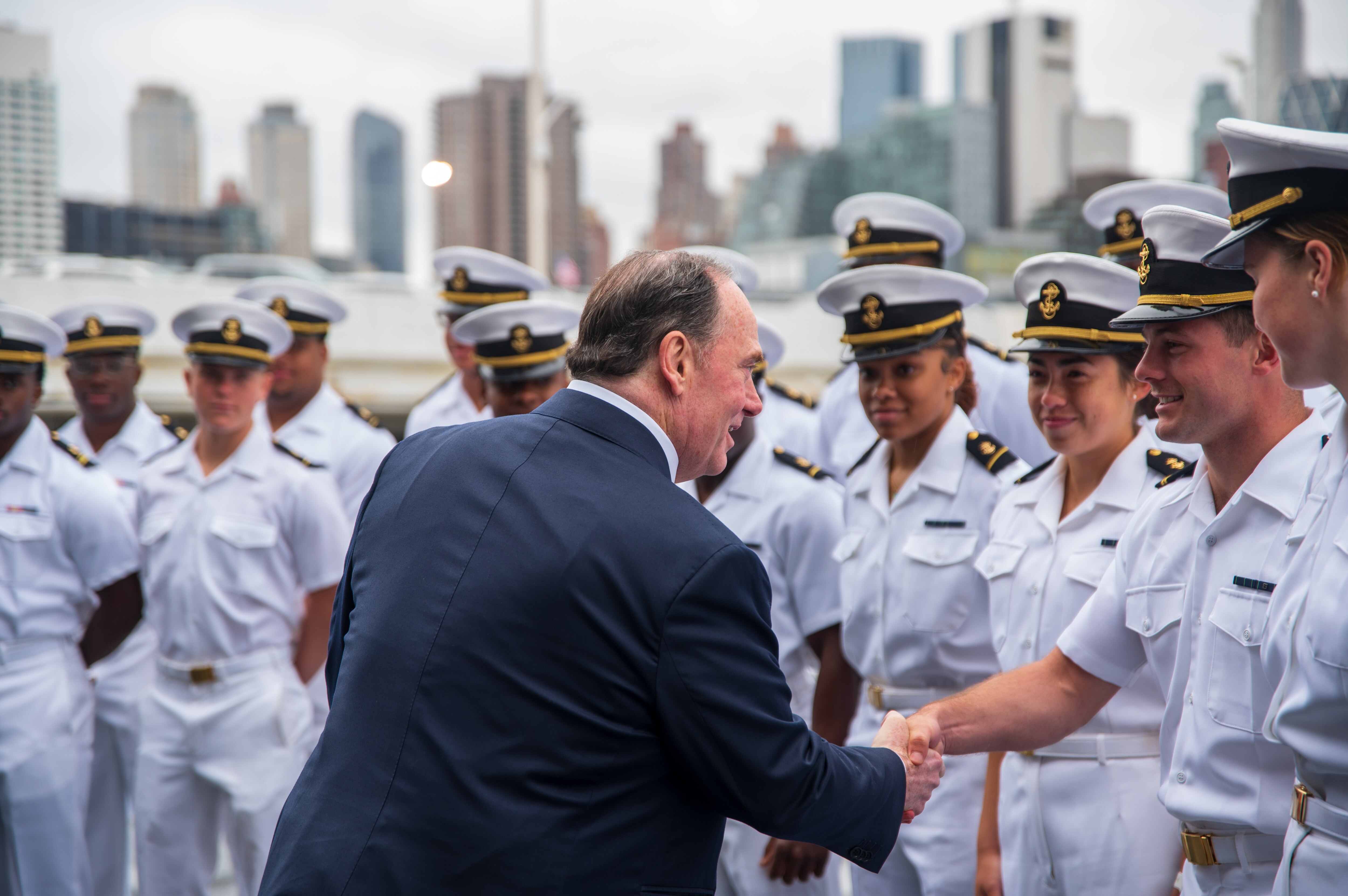 Secretary of the Navy John Phelan greets Naval Academy midshipmen during a tour of the USS New York during Fleet Week New York in May.